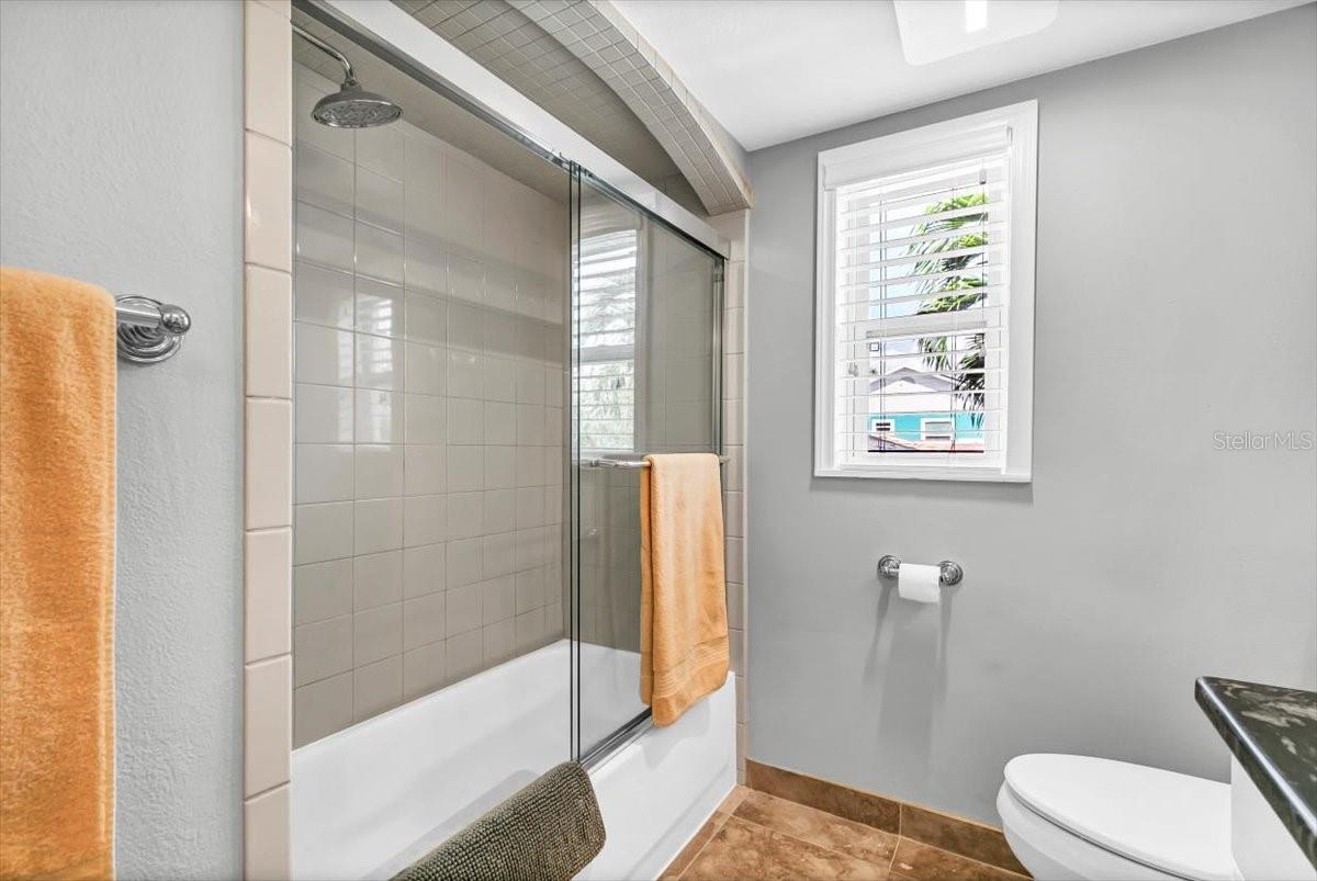 The shower and tub combo with glass doors is also found in the second bedroom