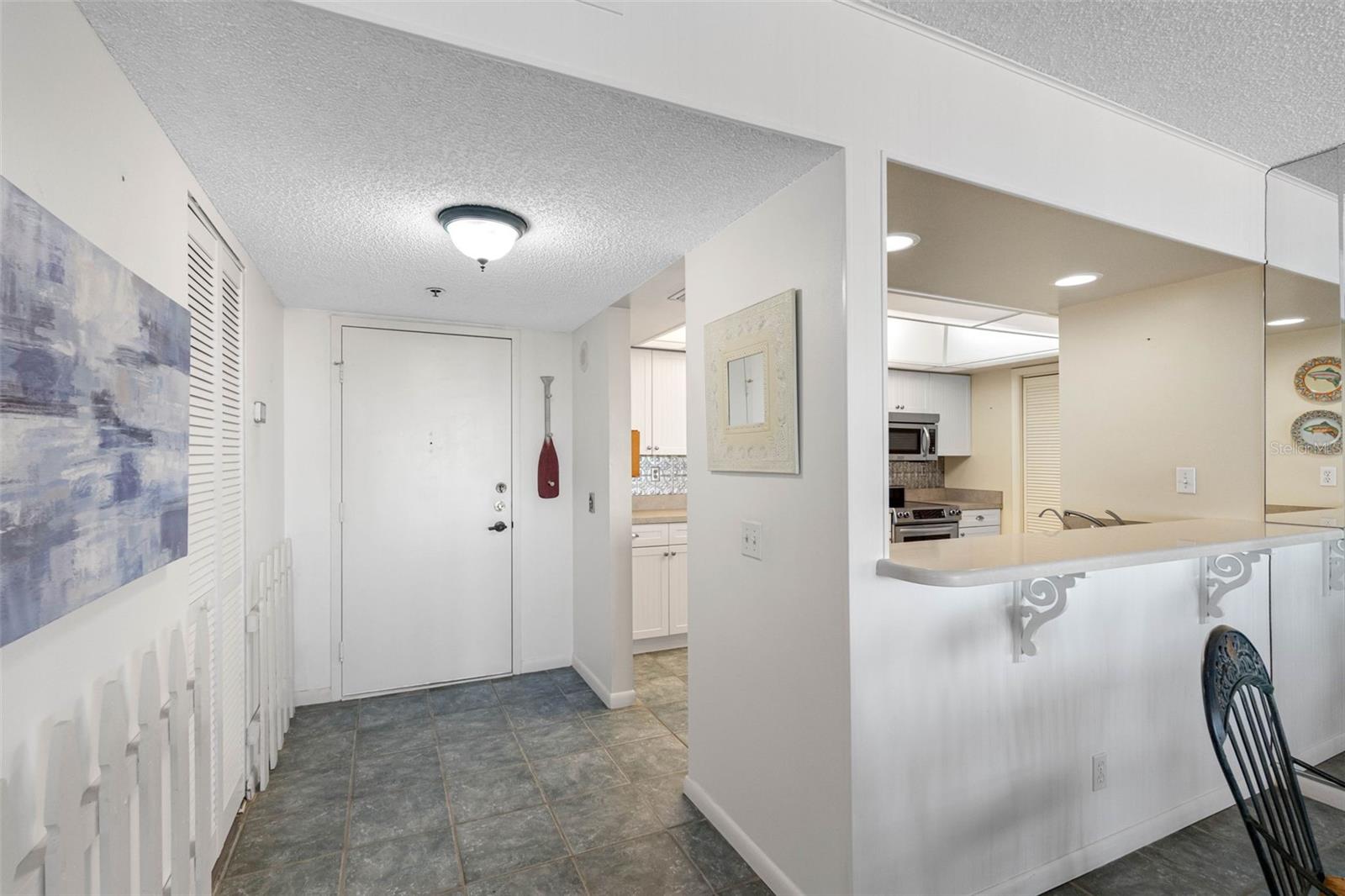 This chef-inspired kitchen features stainless steel appliances, white cabinetry, and a breakfast bar perfect for entertaining.