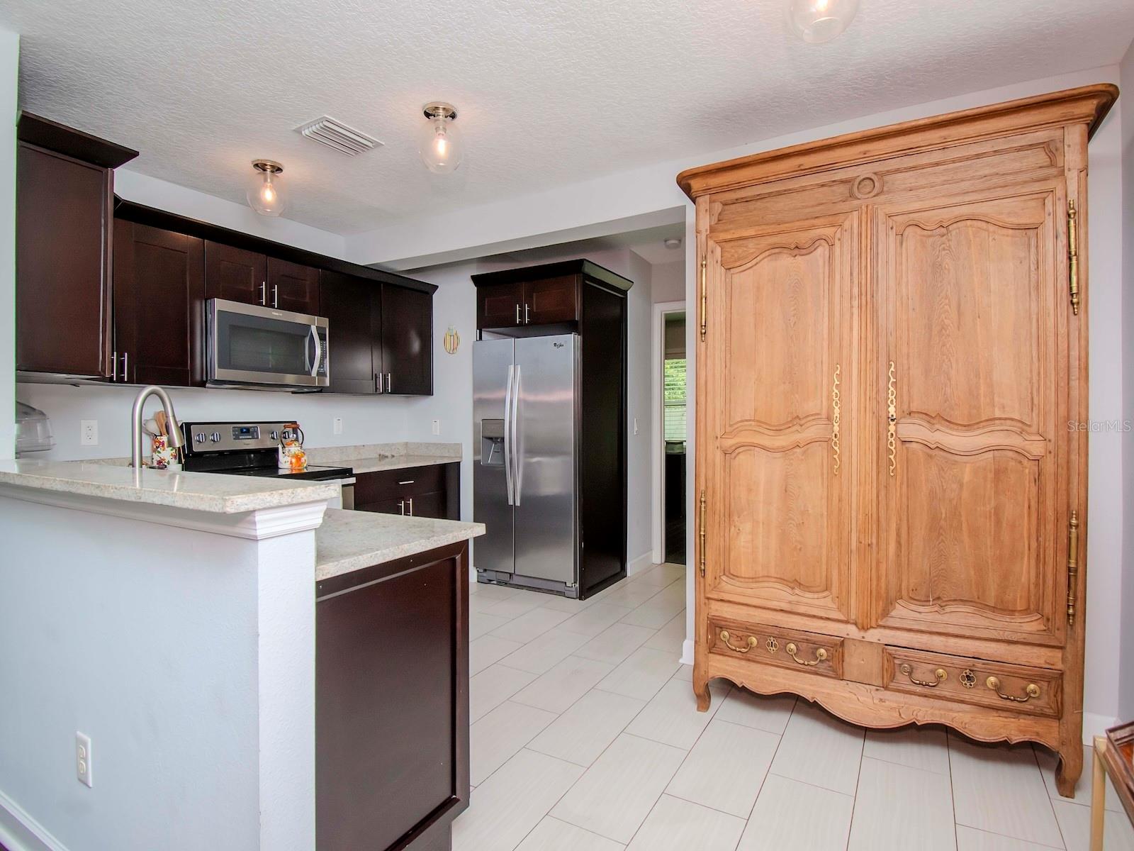 Hide your messy kitchen from your company relaxing in the family & dining rooms.