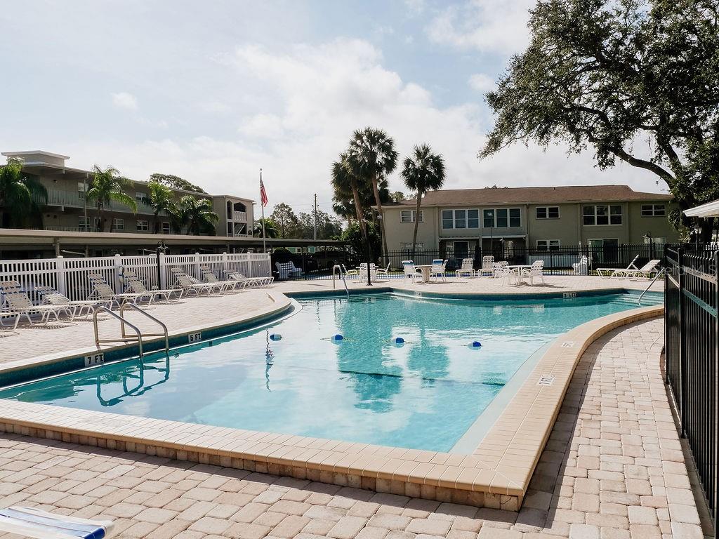 community pool with lounge chairs