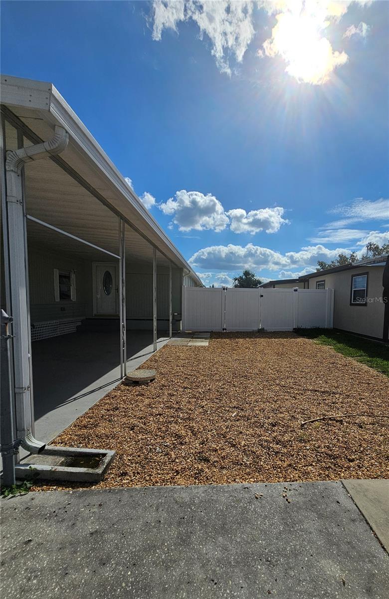 Located to the left of the home. With a double gate.