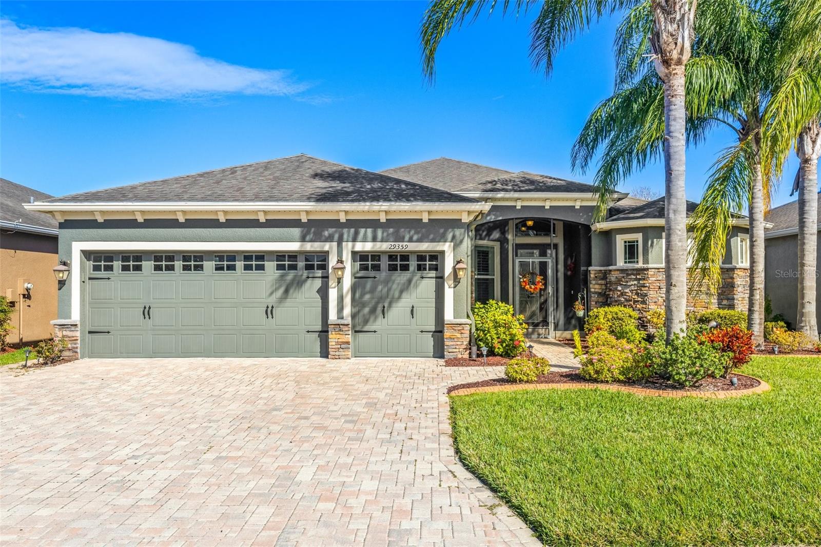 Beautiful home with golf cart garage and pavers.