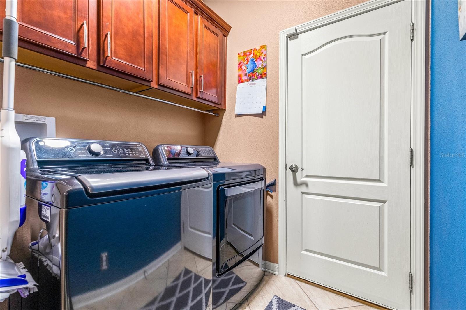 Inside laundry room with storage