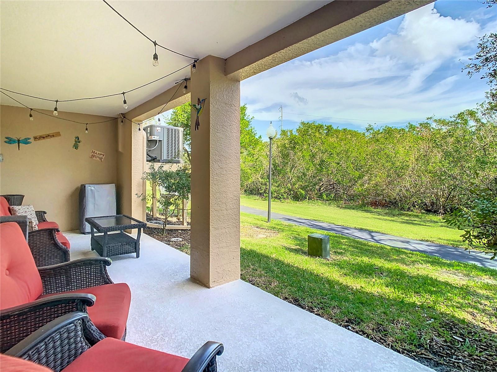 Another view of the patio on the lower level and view of the walking trail