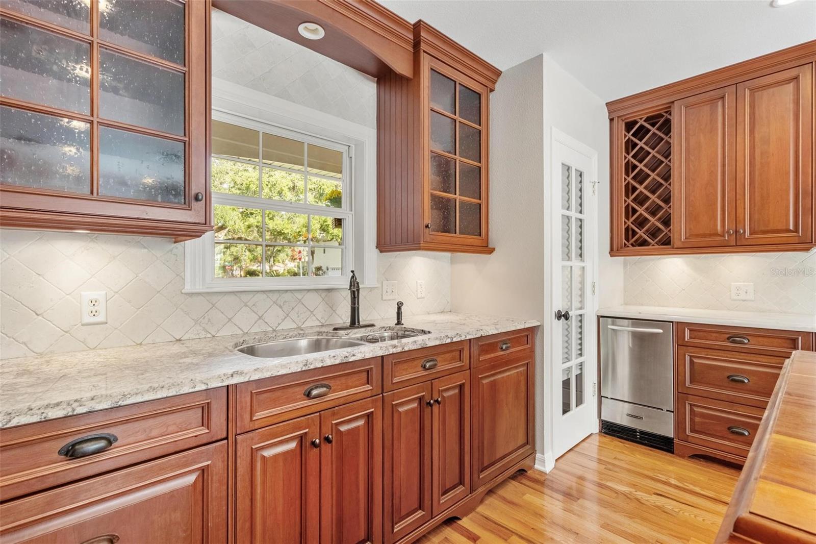 Kitchen including step pantry