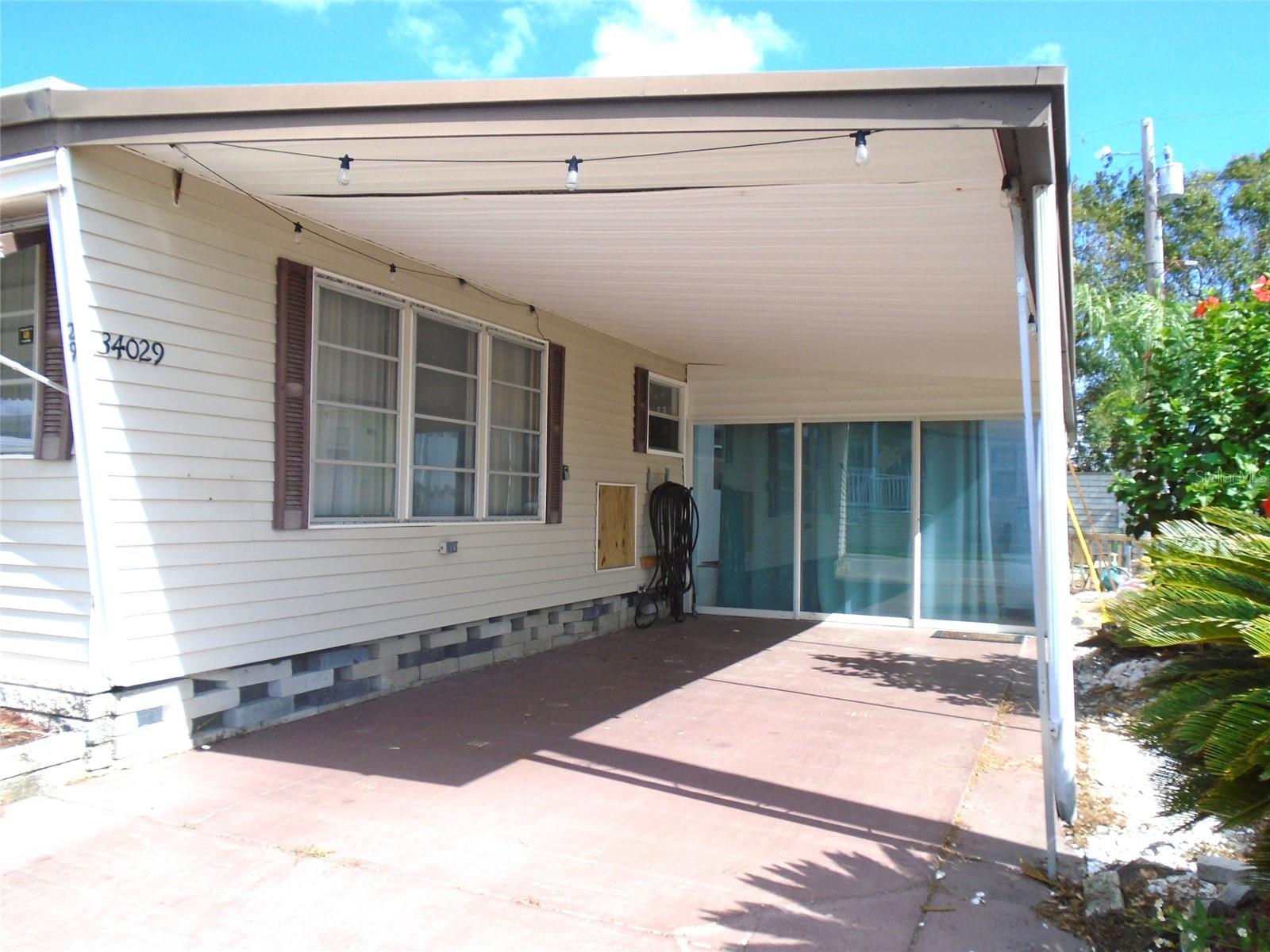 Wide Carport * Glass Doors are to Bonus / Florida Room * Bonus Room has Heat & Air