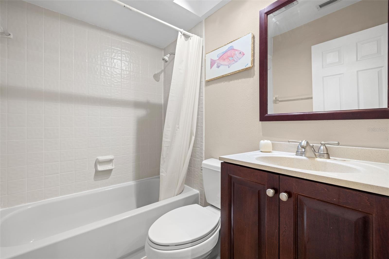 Guest bathroom has a full tub