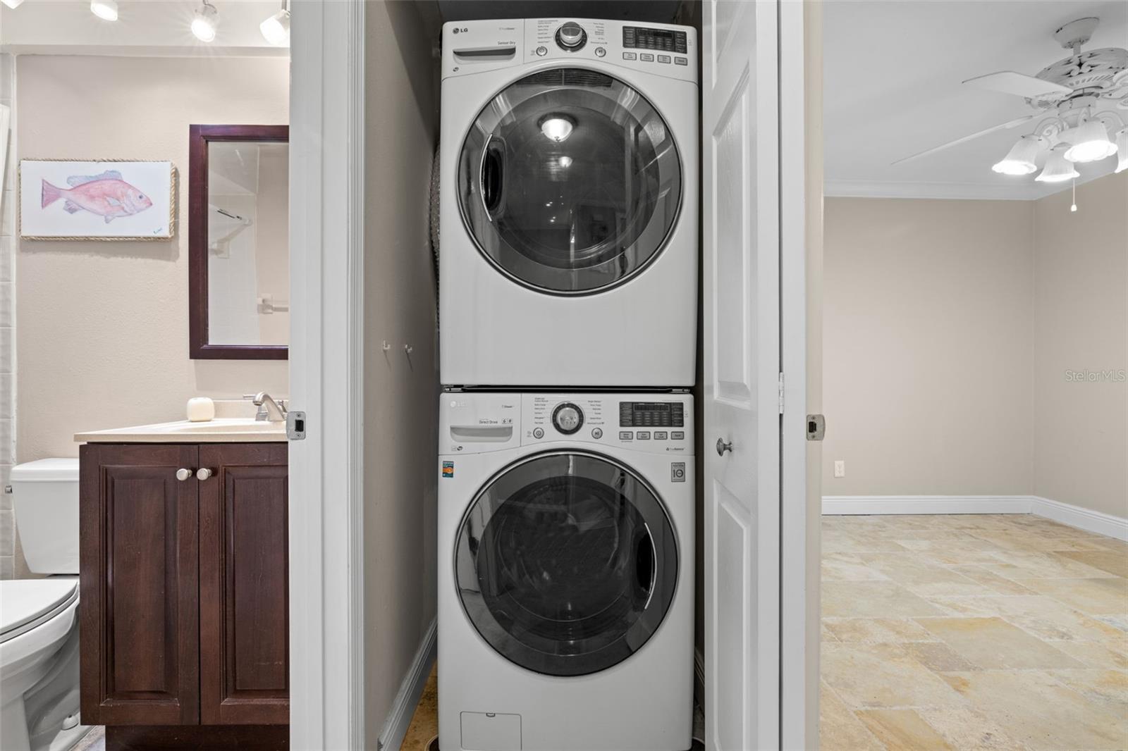 Washer and dryer located in a closet in the guest bathroom