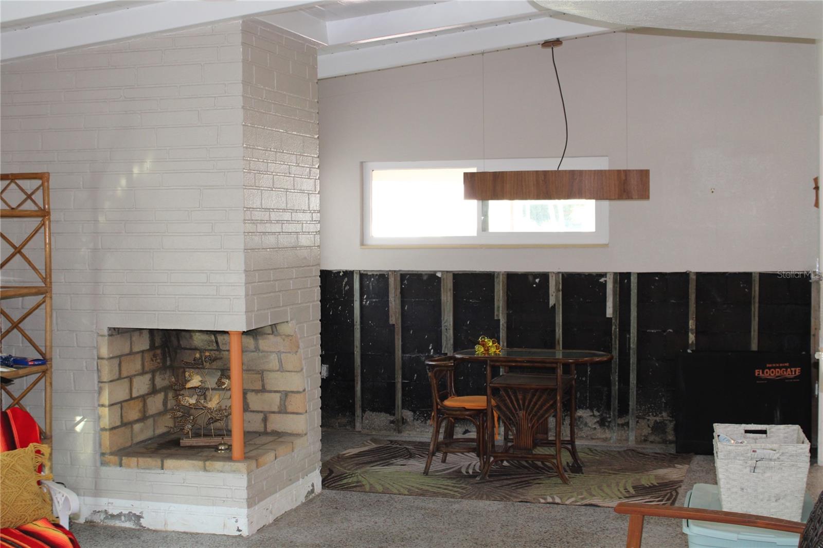 Wood burning fireplace between dining room and living room