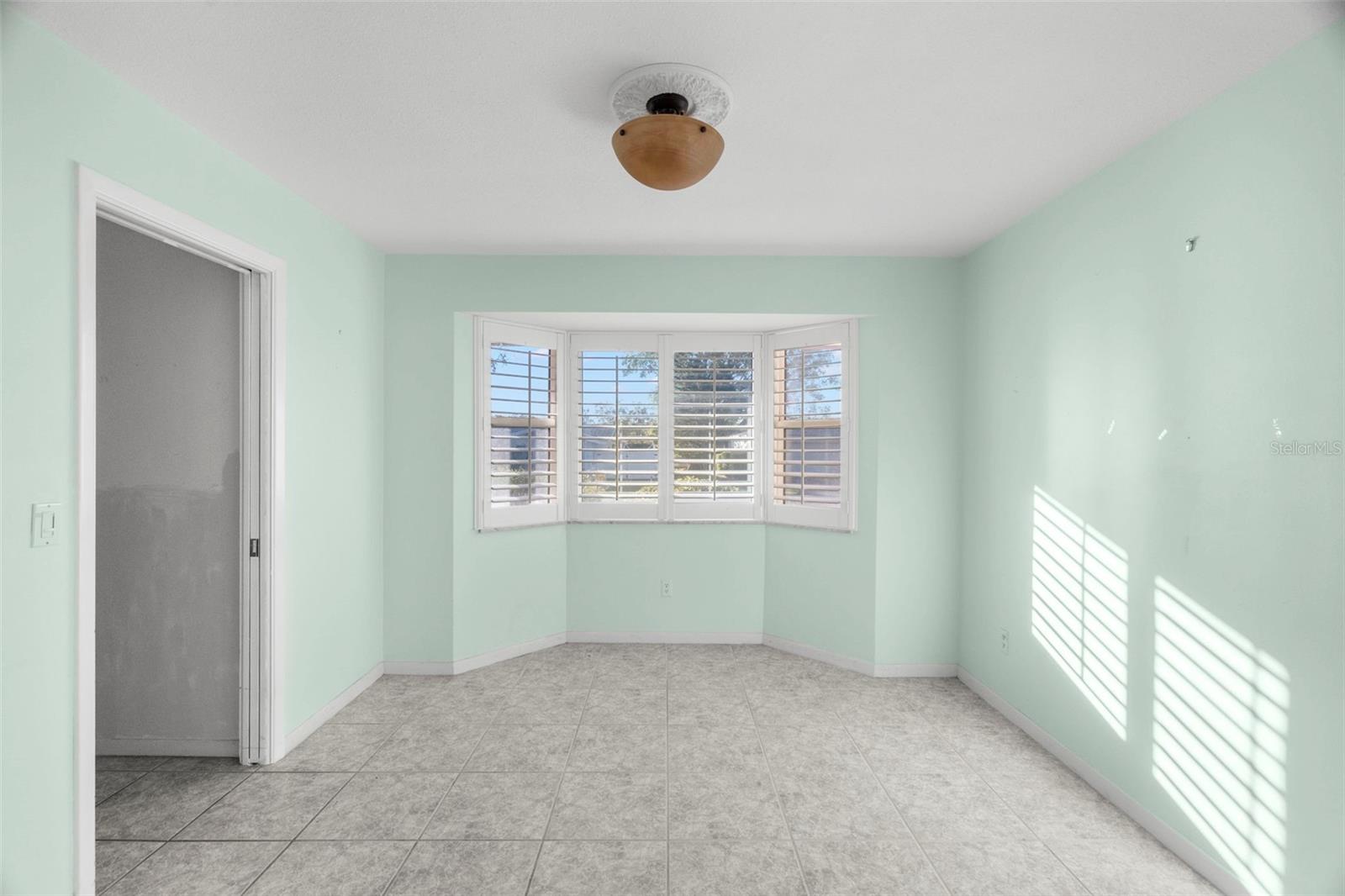 Office with bay window and beautiful plantation shutters