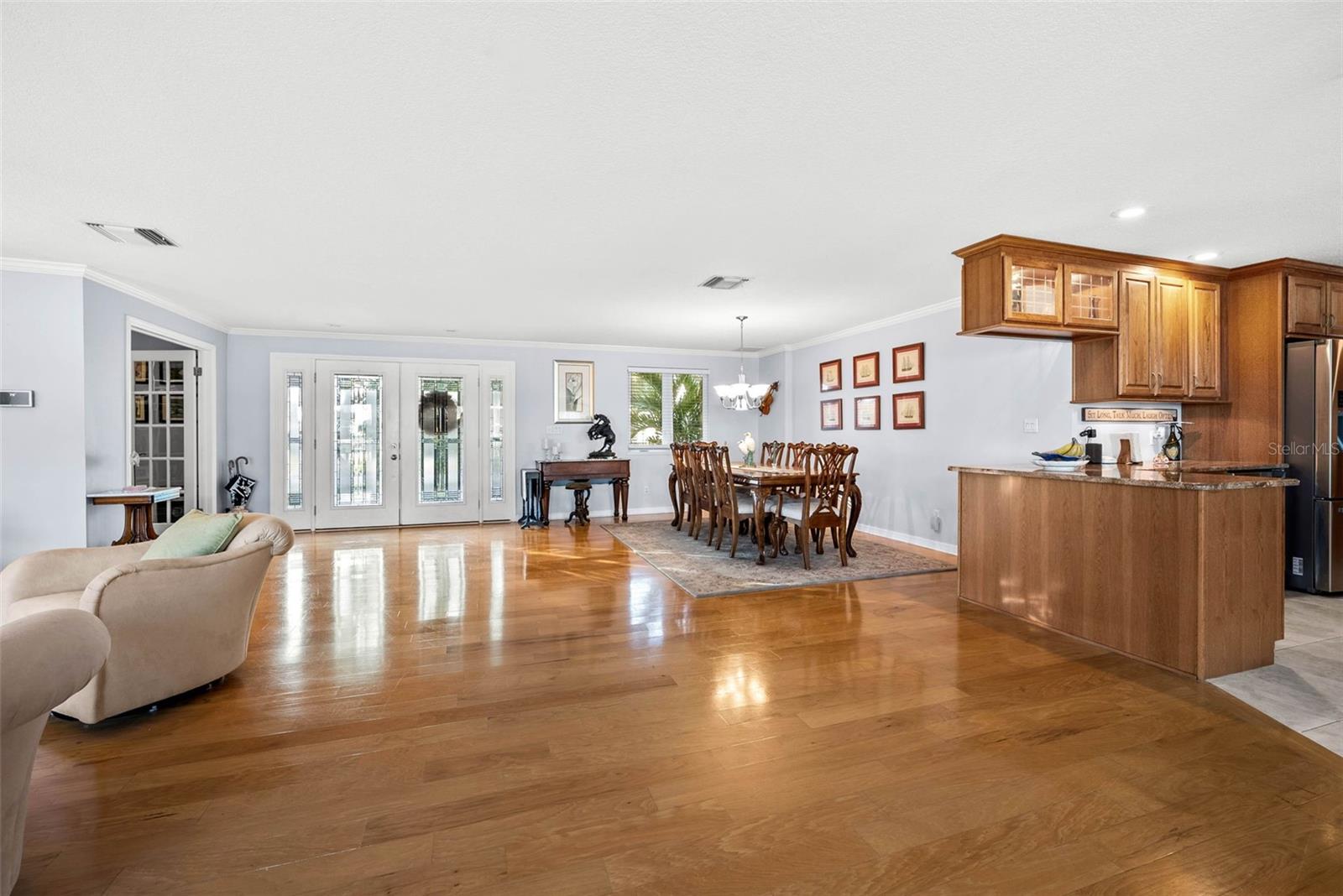 Open Concept view from the kitchen table towards front of house photo from March 2024