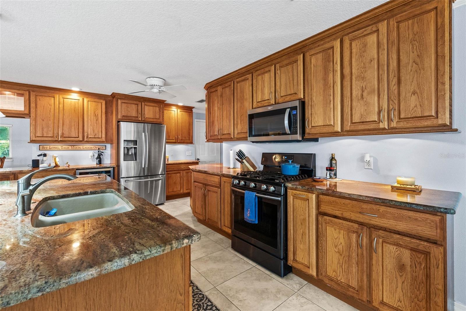 View of the kitchen with island sink photo from March 2024