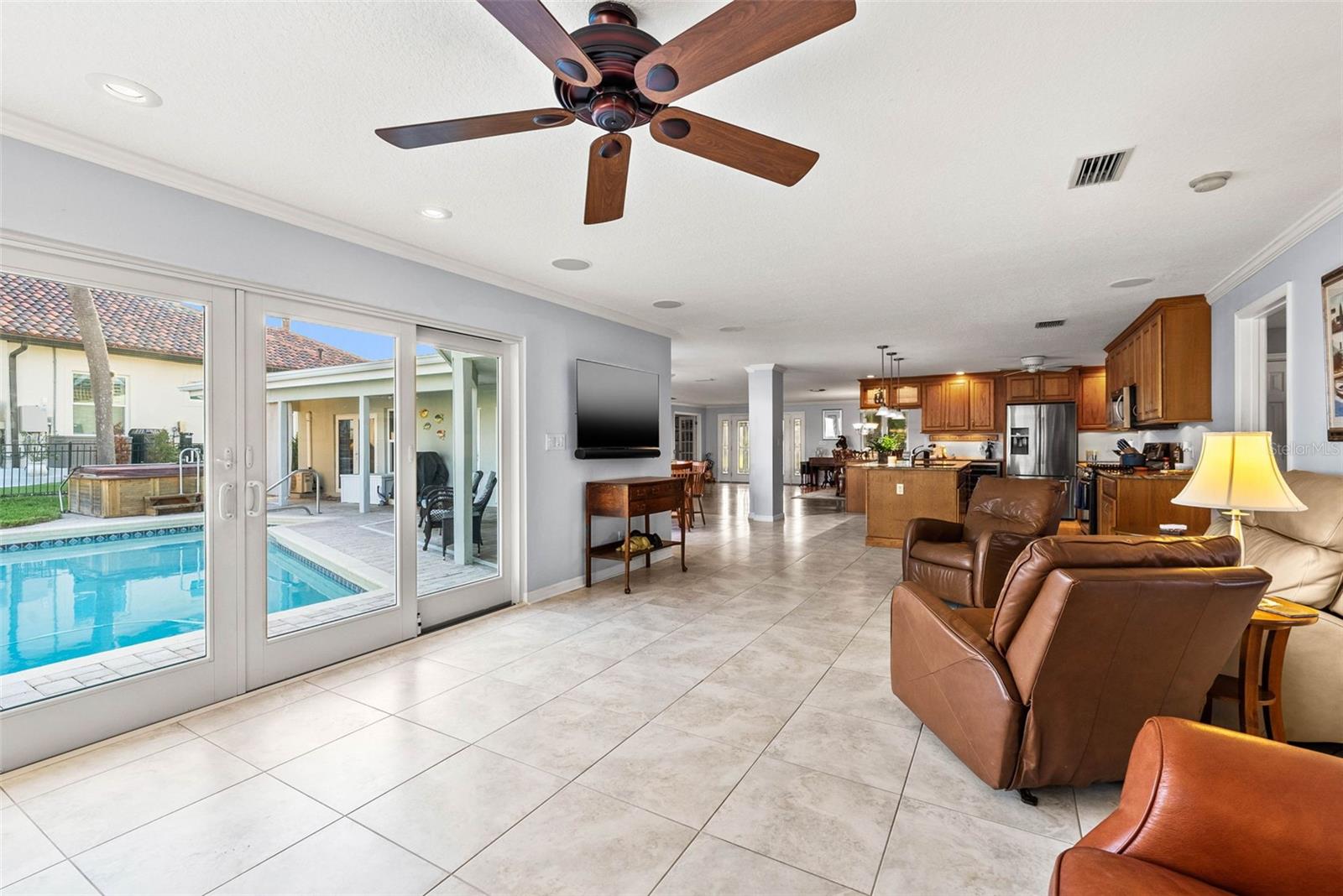 Living area and view of the pool photo from March 2024