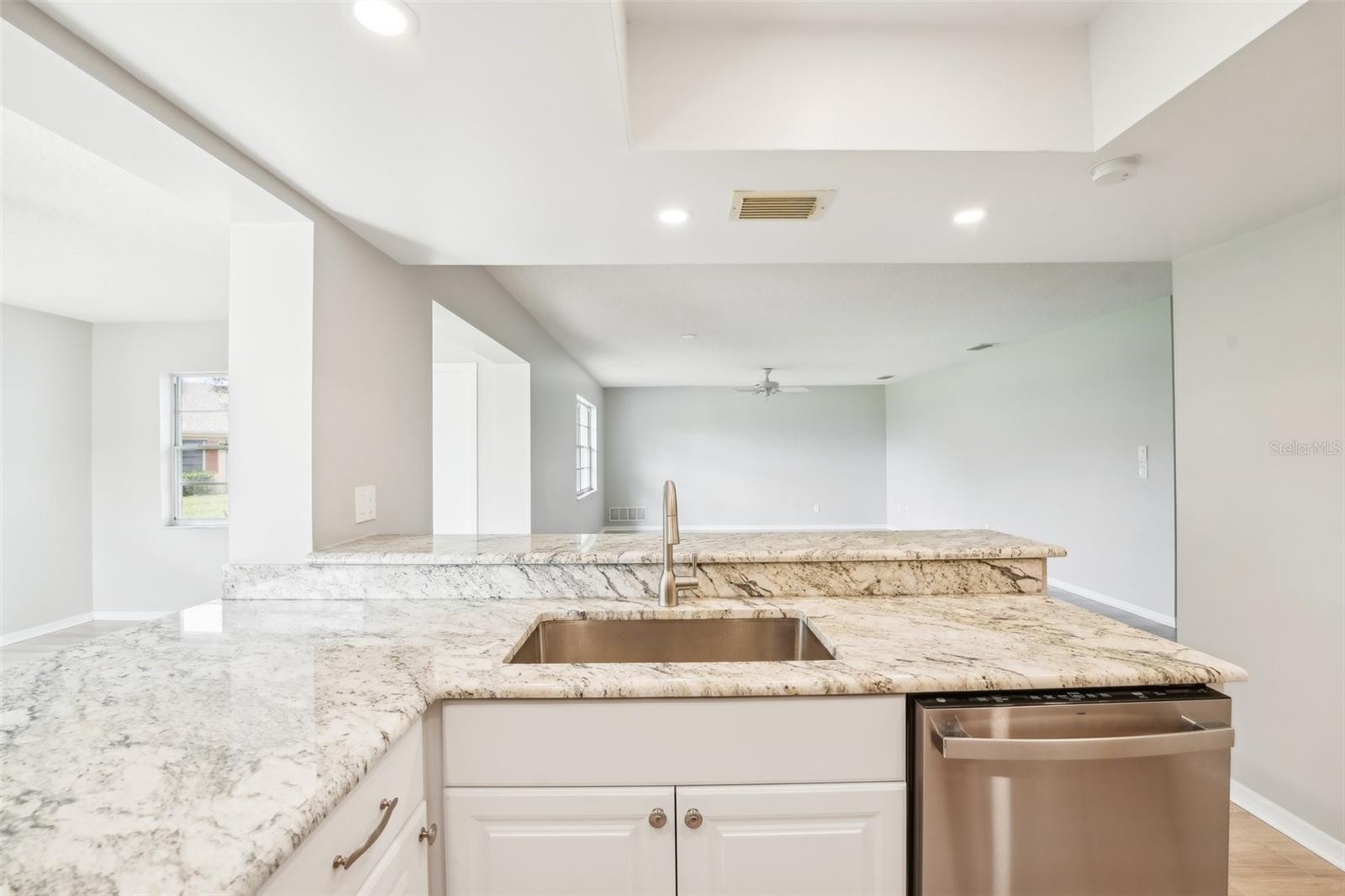 BEAUTIFULLY RENOVATED KITCHEN WITH PASS THROUGH TO THE FLORIDA ROOM AND OPEN TO THE LIVING ROOM