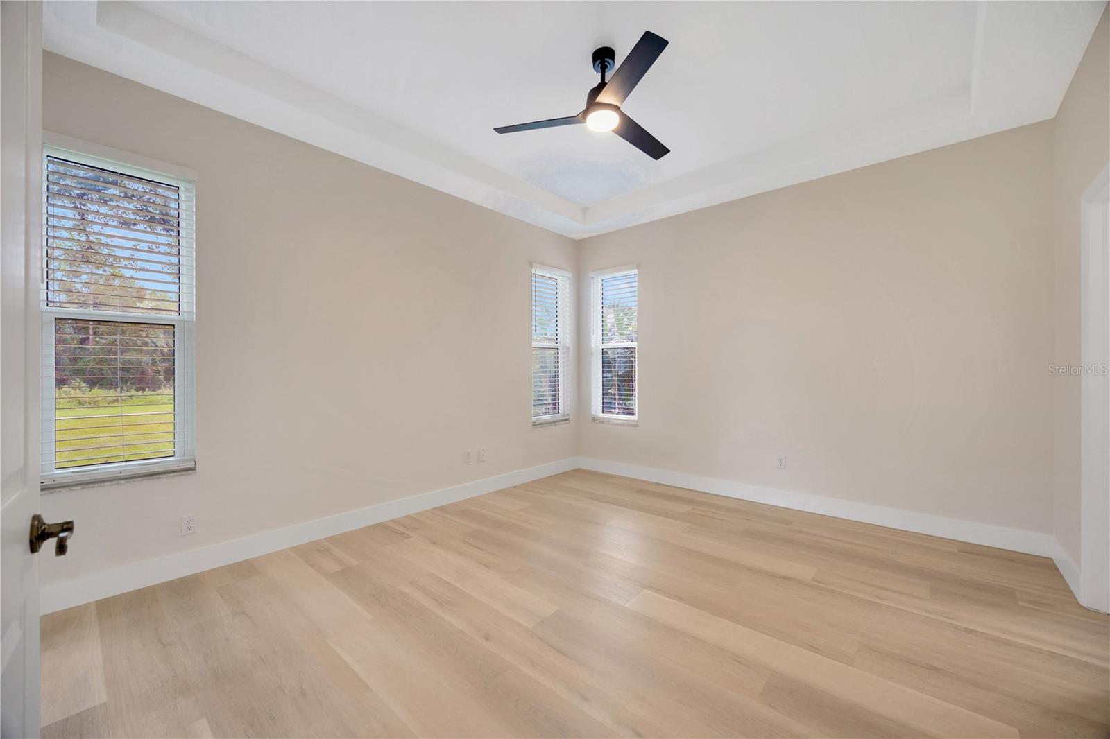 Primary En Suite featuring sliders to the lanai, walk-in closet, and bathroom!