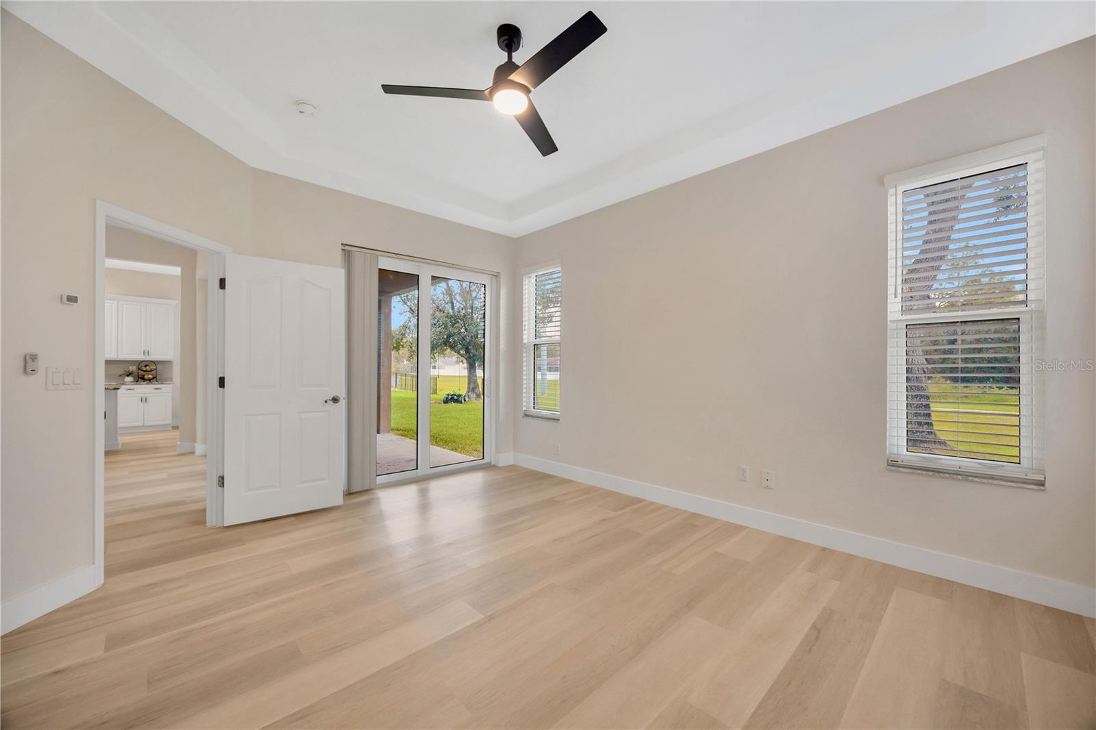 Primary En Suite featuring sliders to the lanai, walk-in closet, and bathroom!