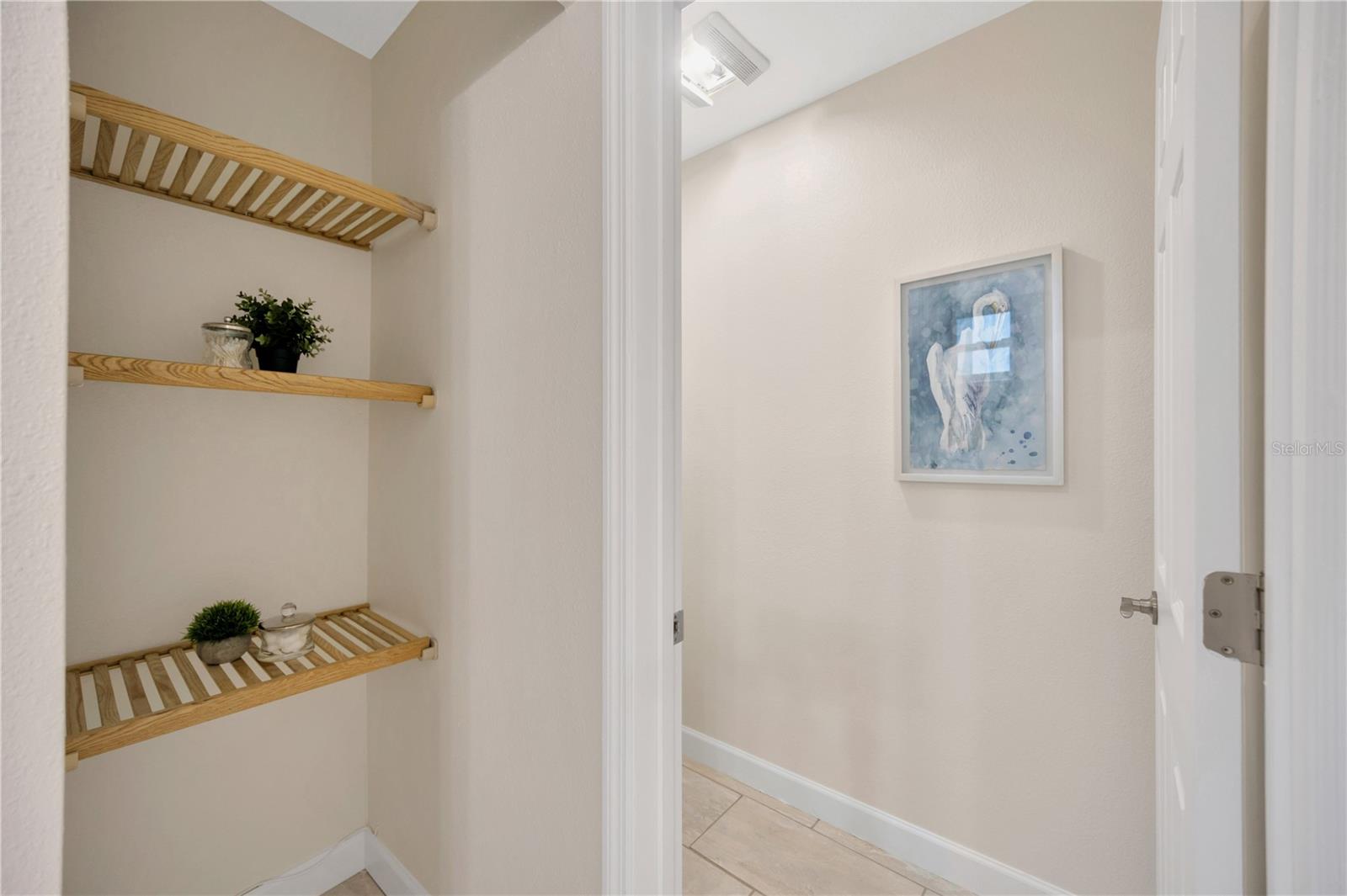 Primary bathroom with dual sinks, seamless glass shower, and walk in closet!