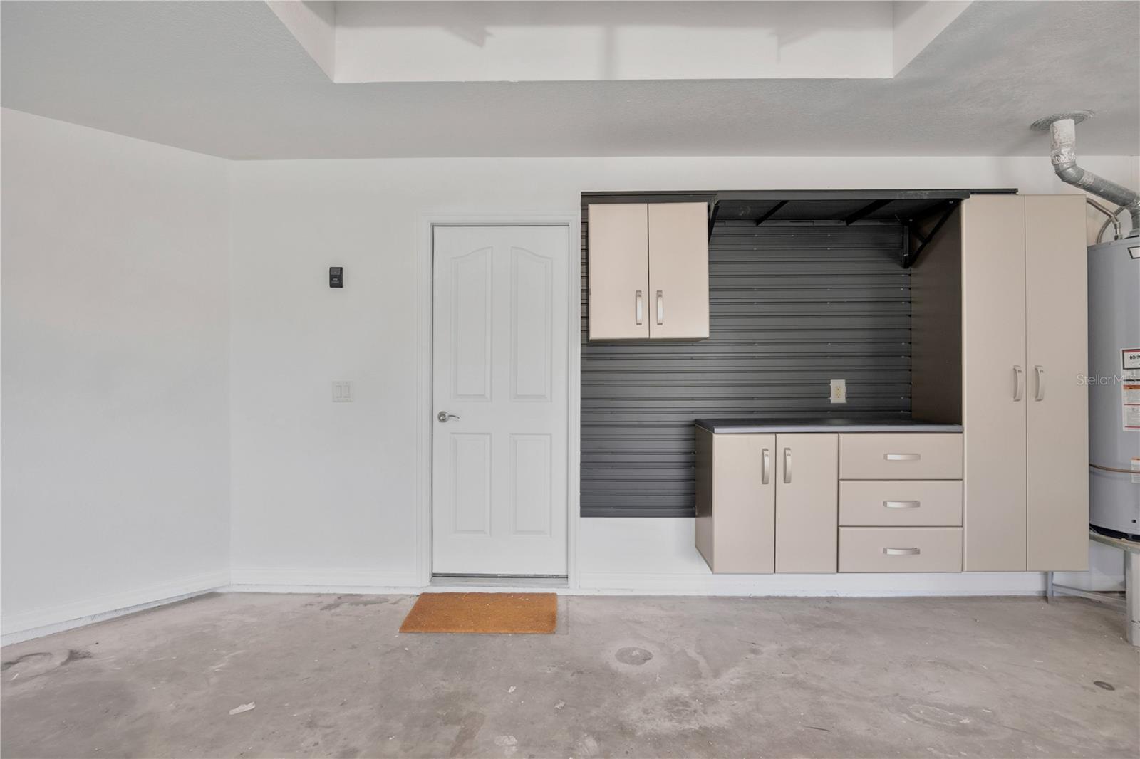 Nicely sized garage with built in cabinets and hangboards for ample storage.