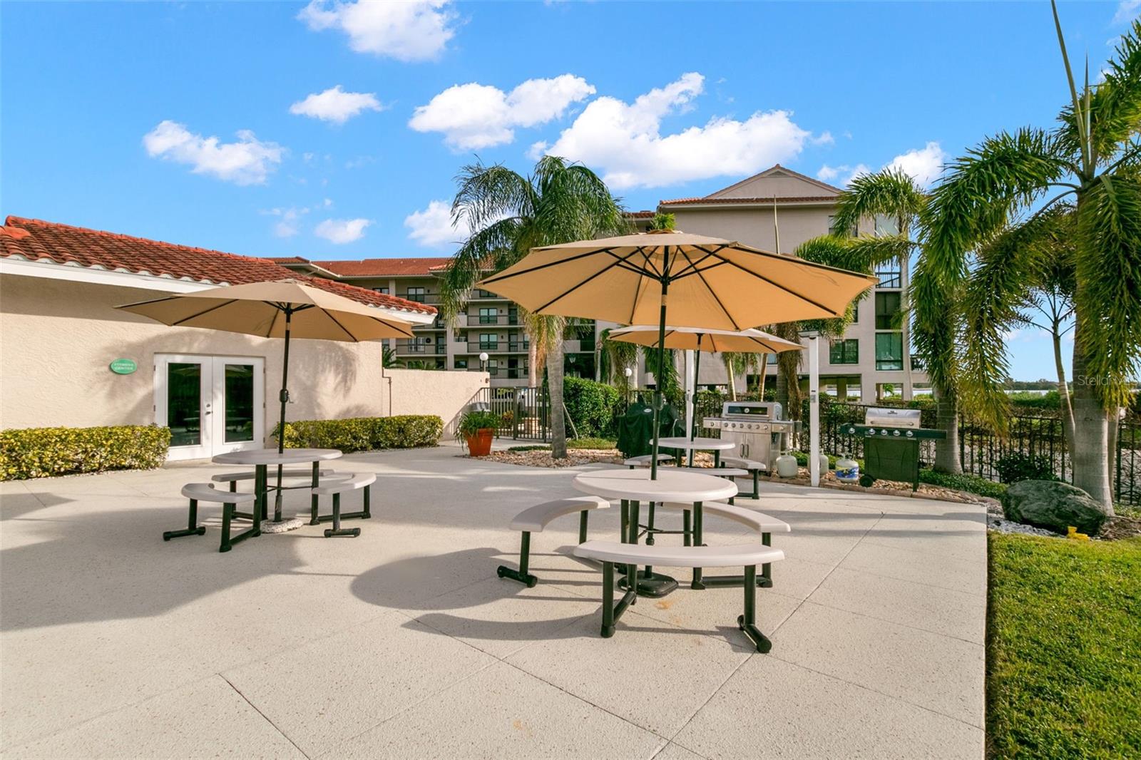 Picnic tables and grills by the Clubhouse and pools