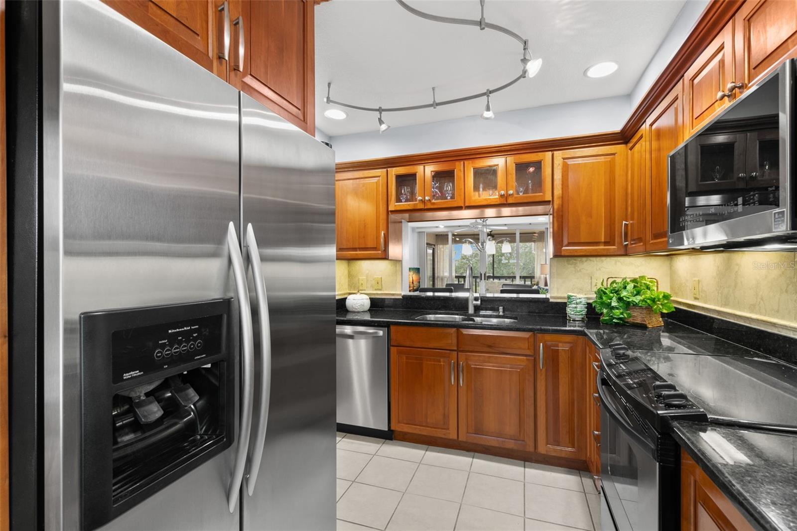 Beautiful upgraded kitchen with custom solid wood cherry cabinets that are 13-inches deep and stainless steel appliances