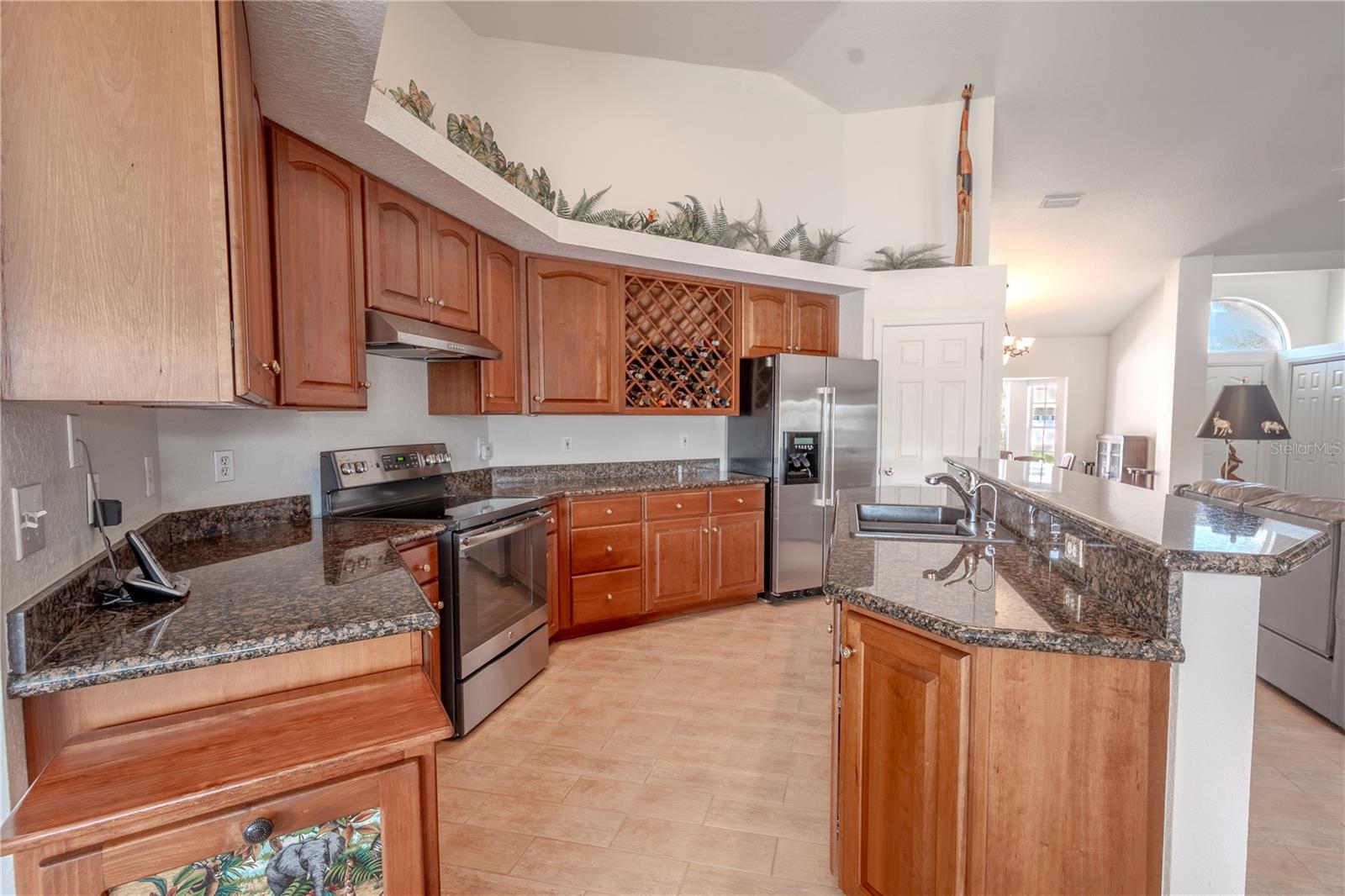 The kitchen features a suite of stainless steel appliances, granite countertops and solid wood cabinets and drawers.