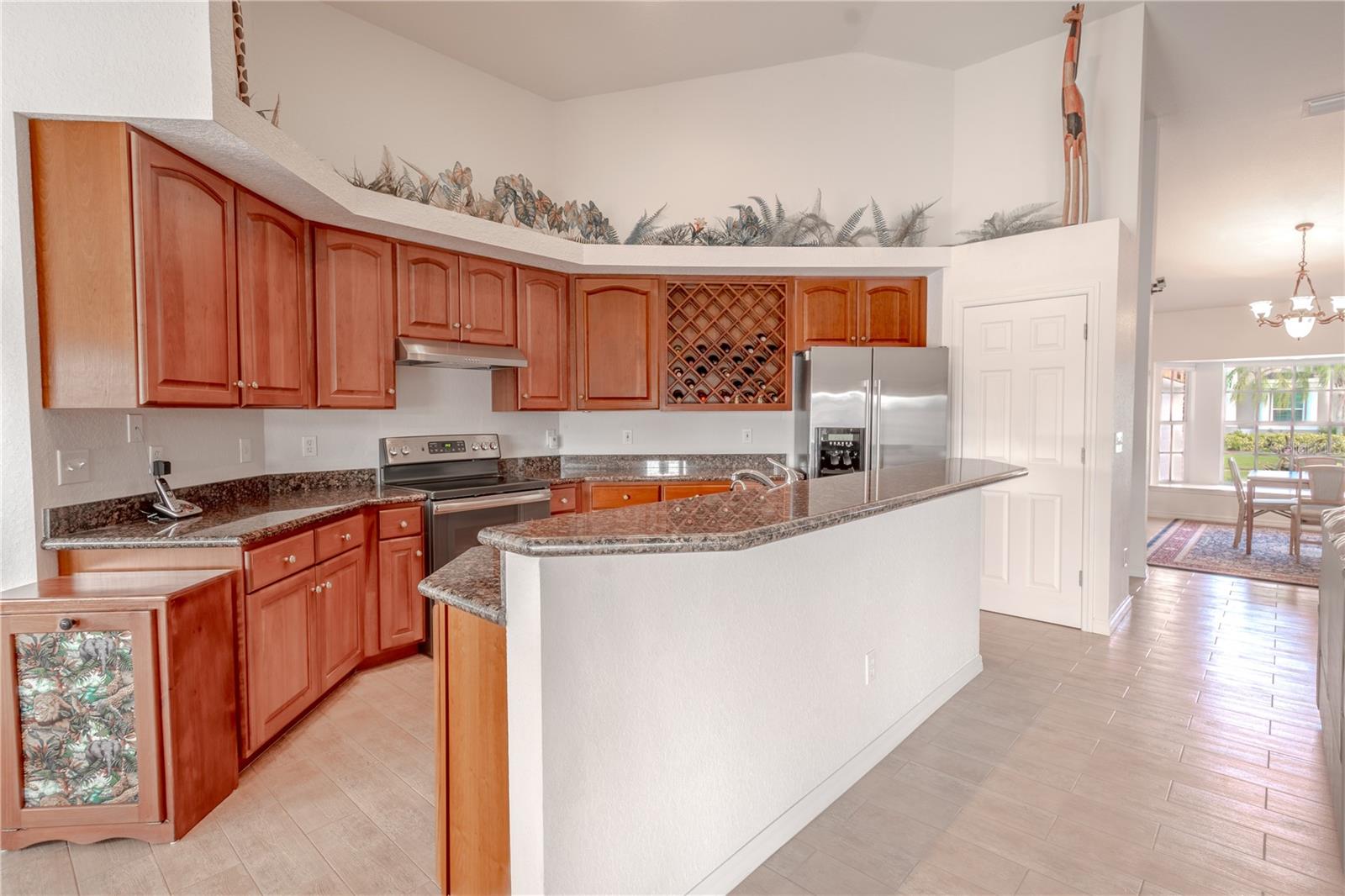 The kitchen has a breakfast bar with additional seating.