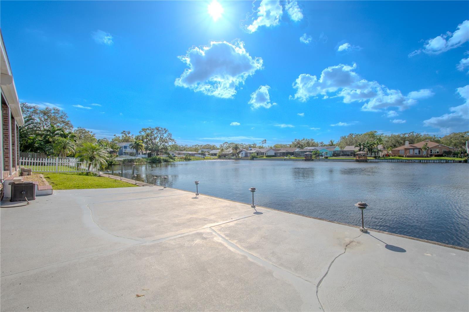 The backyard patio has lighting and stunning water views.