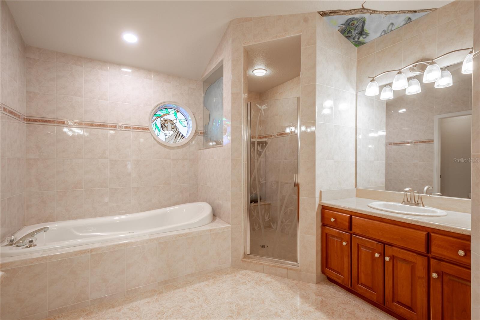 The primary bedroom features a garden style tub and separate shower.