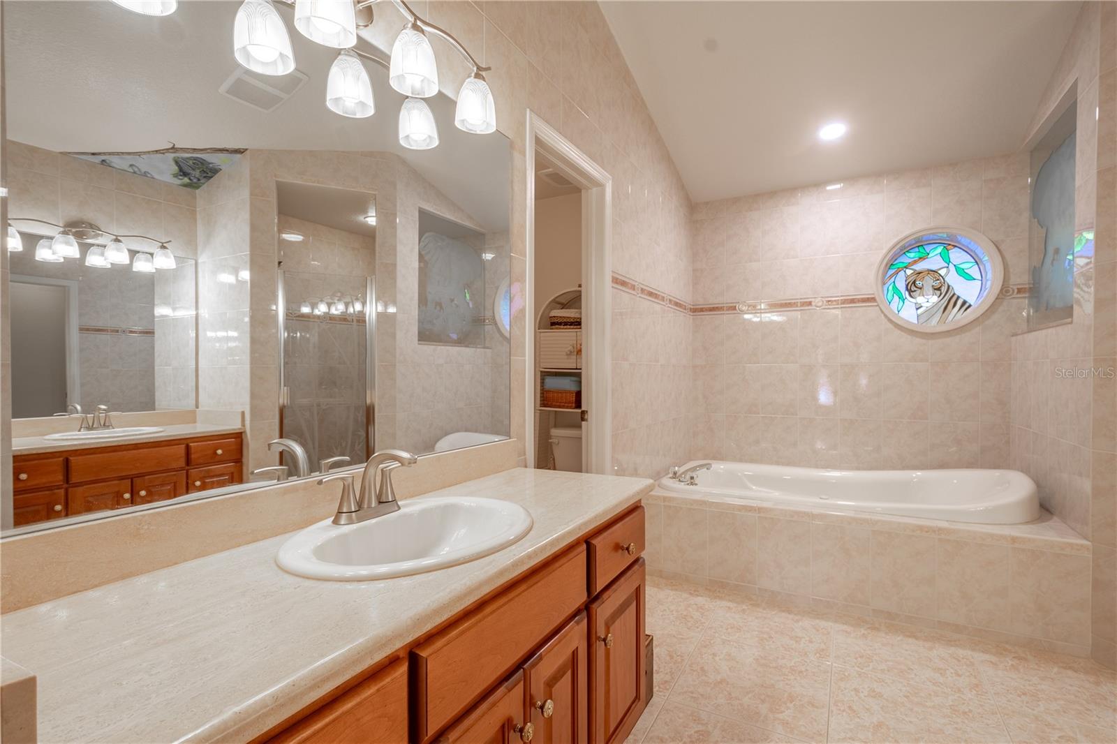 The ensuite features his and hers vanities.