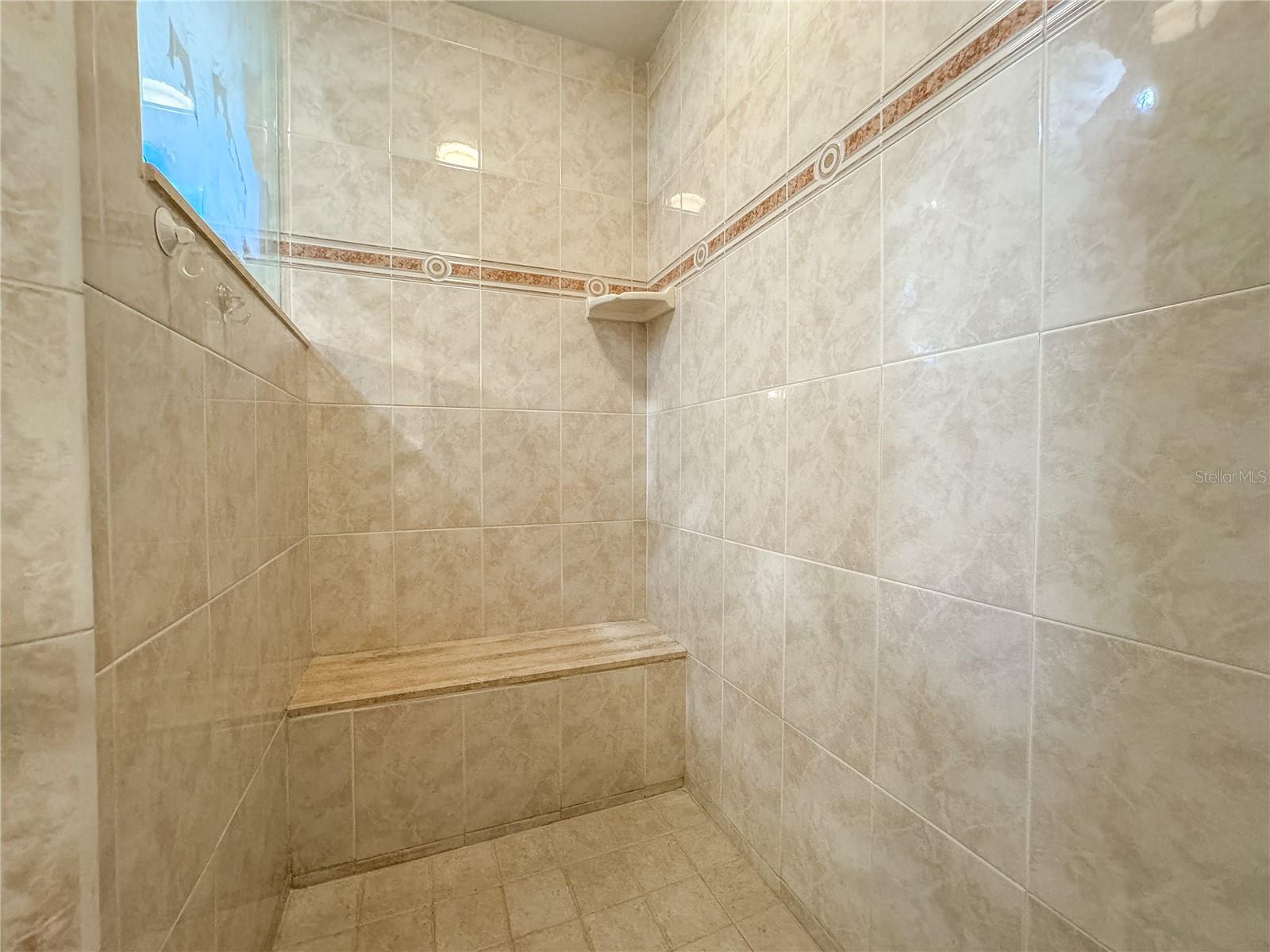 The primary ensuite features a walk-in shower with built-in shower bench.