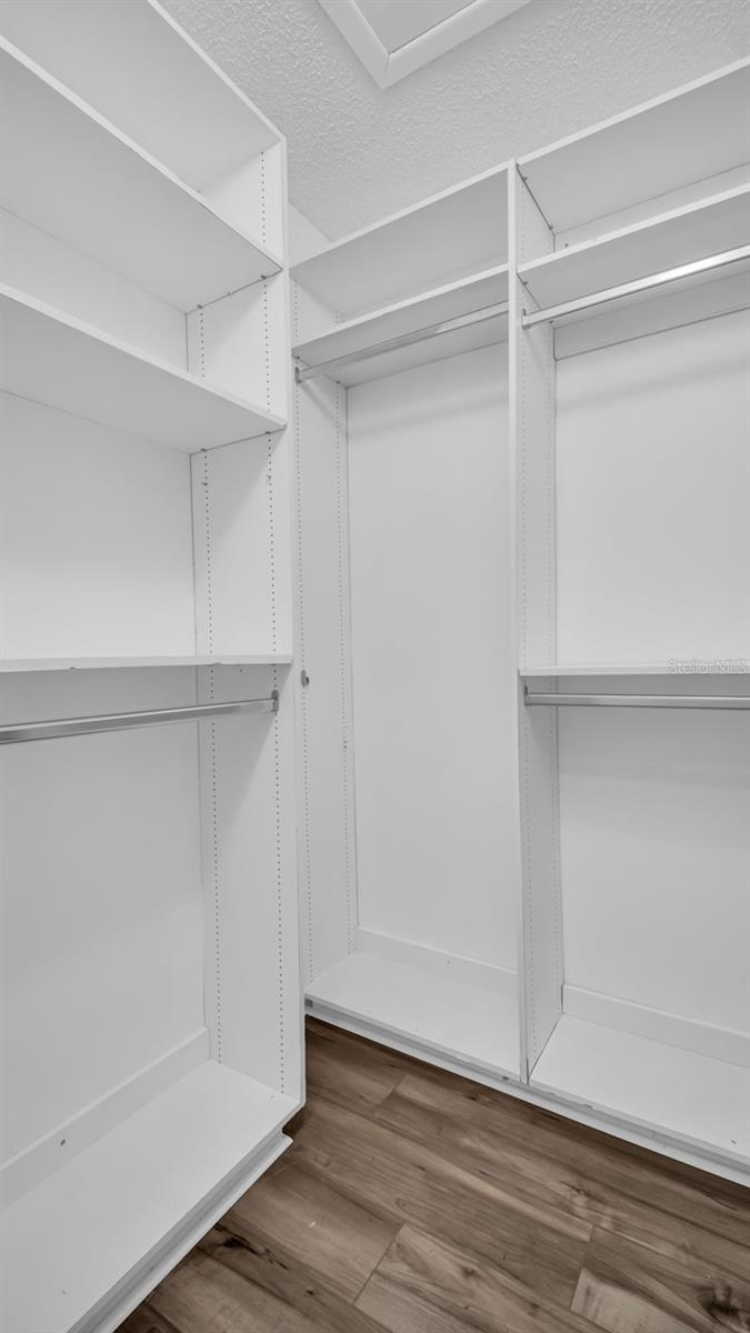 Large walk-in closet with built in shelving