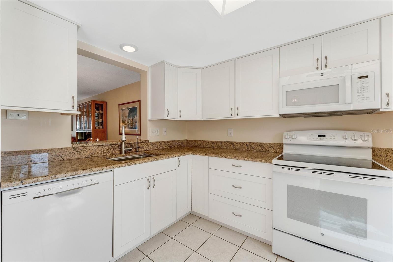 Updated kitchen with granite countertops & open to main living~