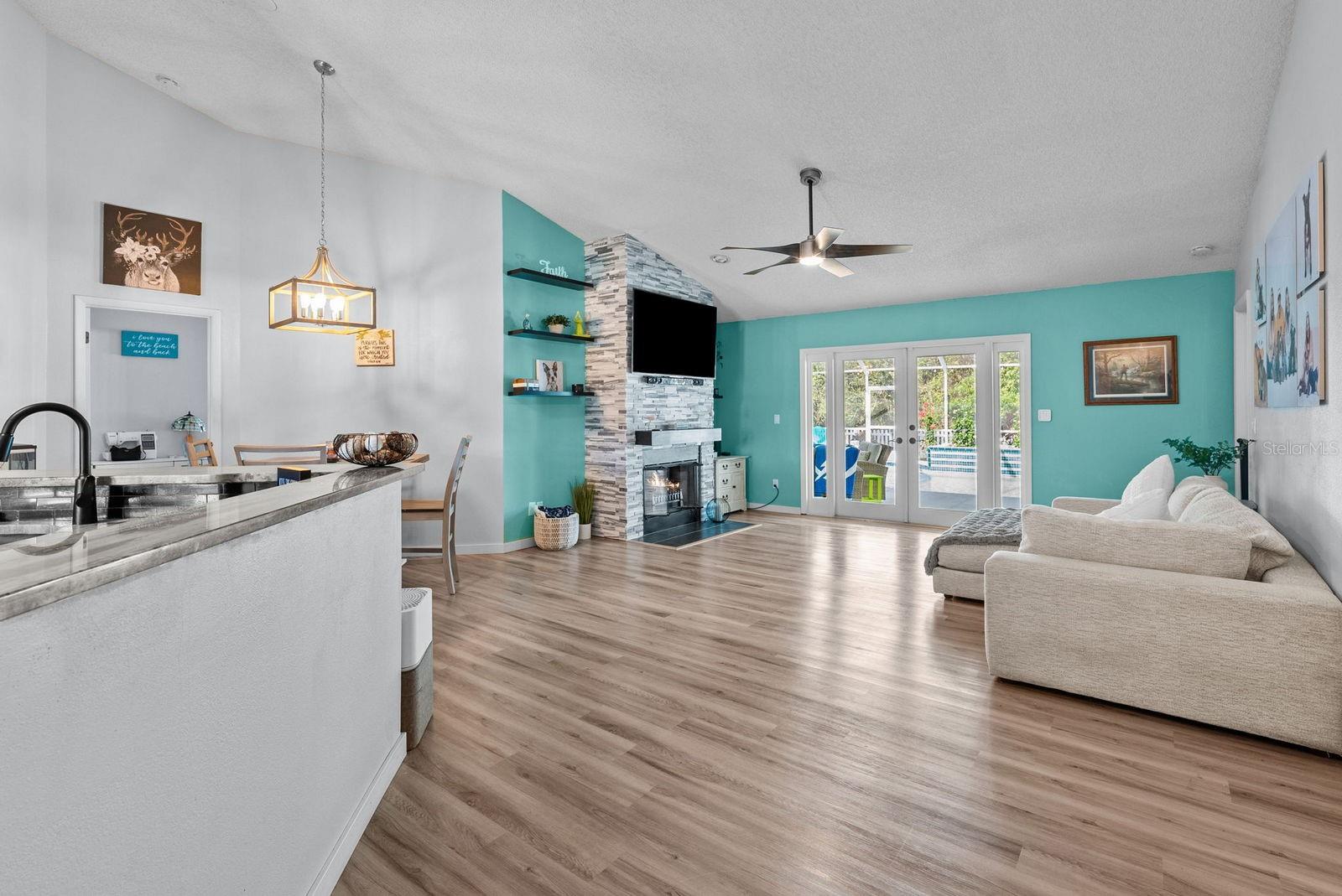 Open living and dining room area with great views of the pool and conservation