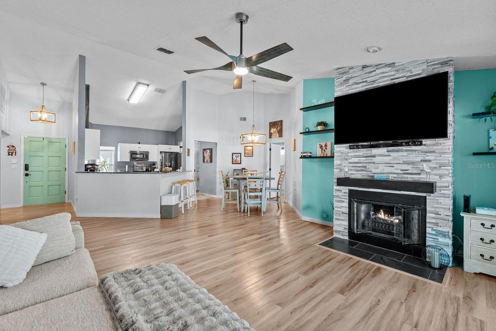 Living room area with view of kitchen and dining room