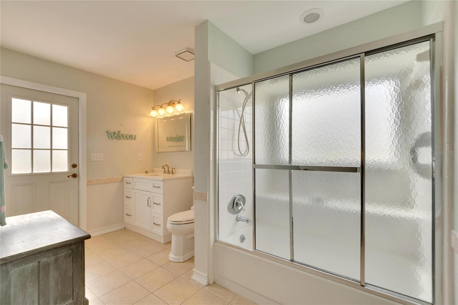 Bathroom number two/ pool bath.  Step in tub with bench.