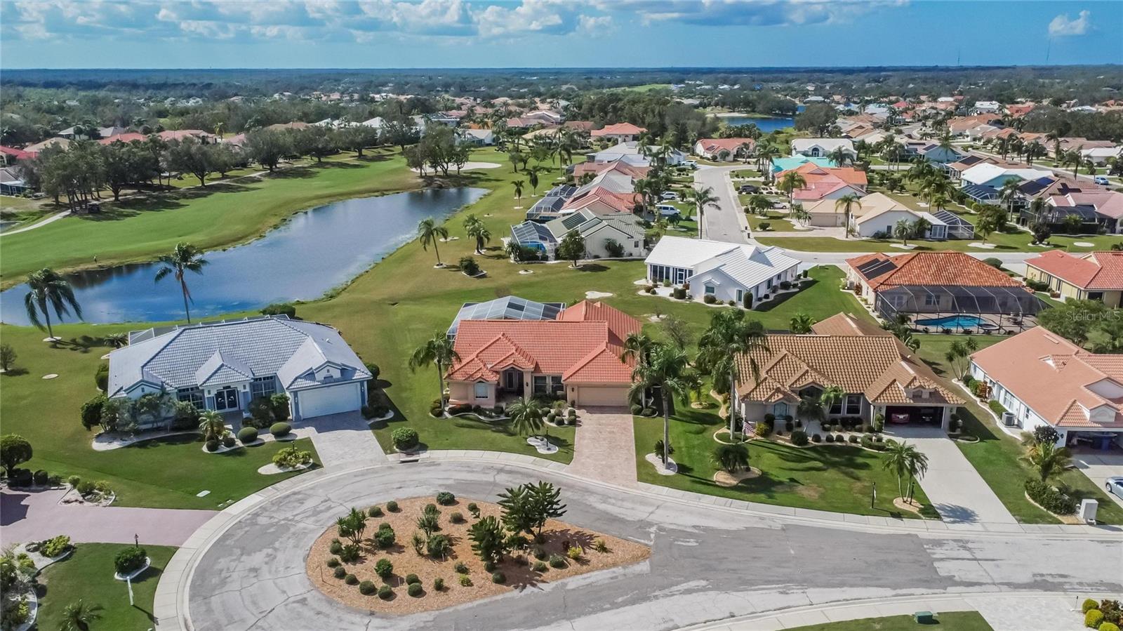 Your home is the one with the terra cotta roof.  Stunning views of a tranquil pond, and golf course.  The pond offers a buffer between the heated pool and spa.  Golf cart path is on the other side of the fairway.