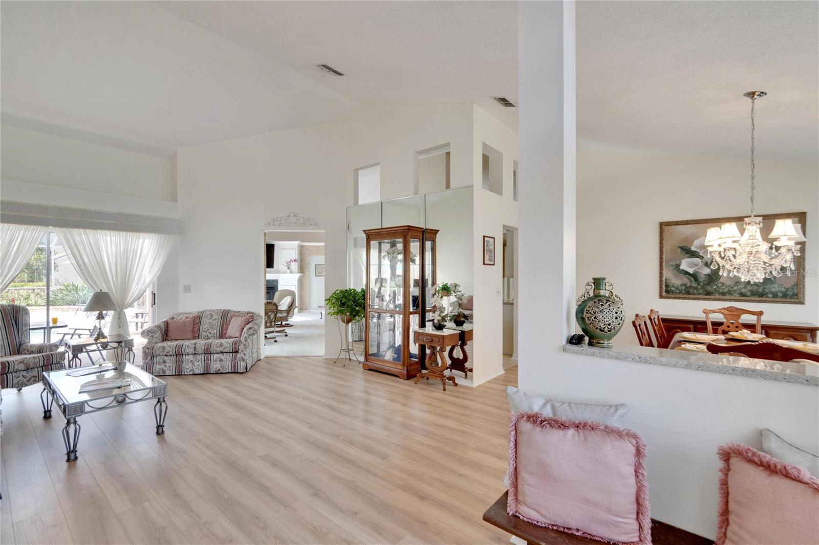 View is from foyer overlooking living room, dining room, into the family room.  Living room measures approximately 14x16.