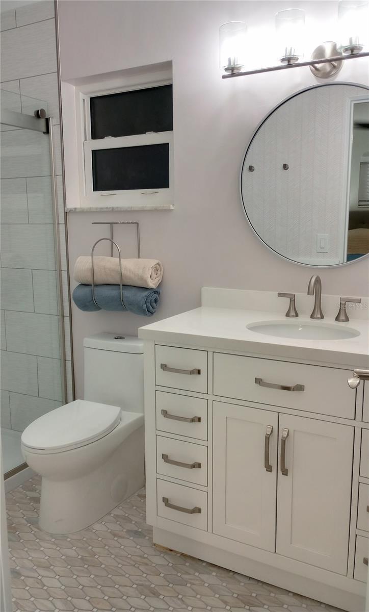 Ensuite features: Oversized vanity, skirted toilet and designer tile.