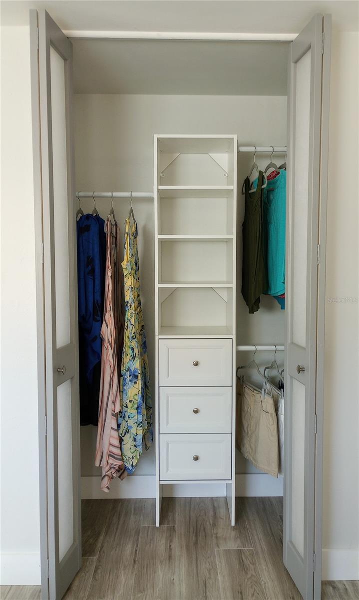 Primary bedroom features two closets with built in organizers.