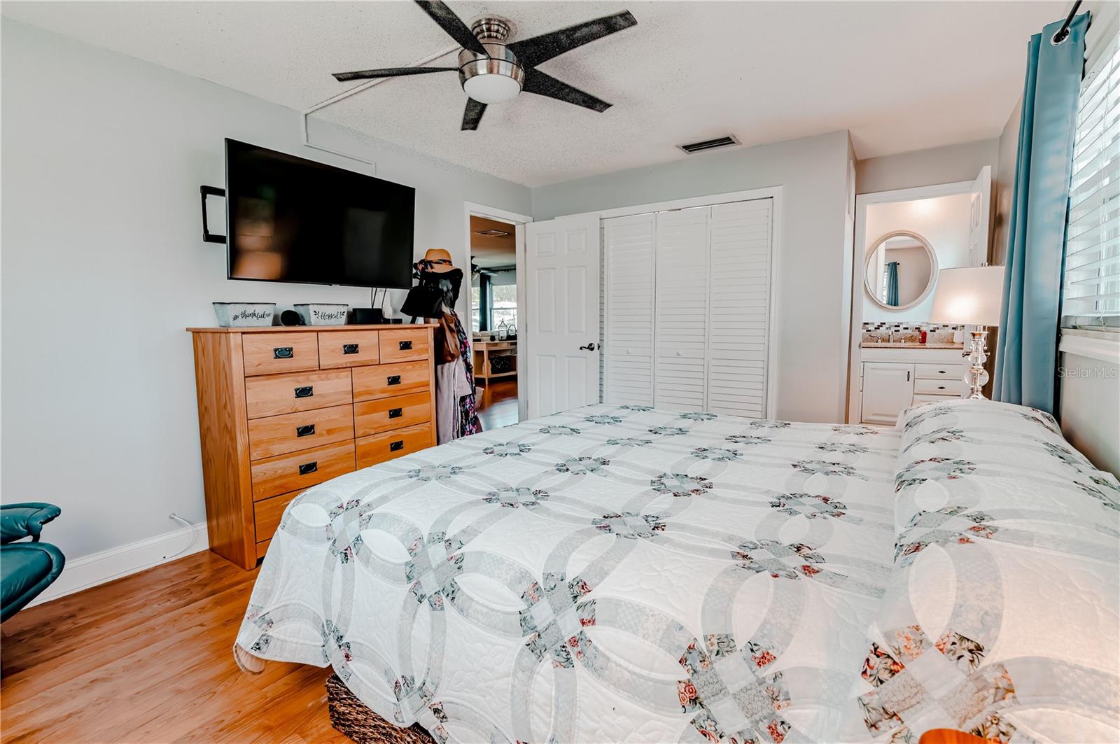 The opposite view of the primary bedroom showing the closet doors and bathroom.