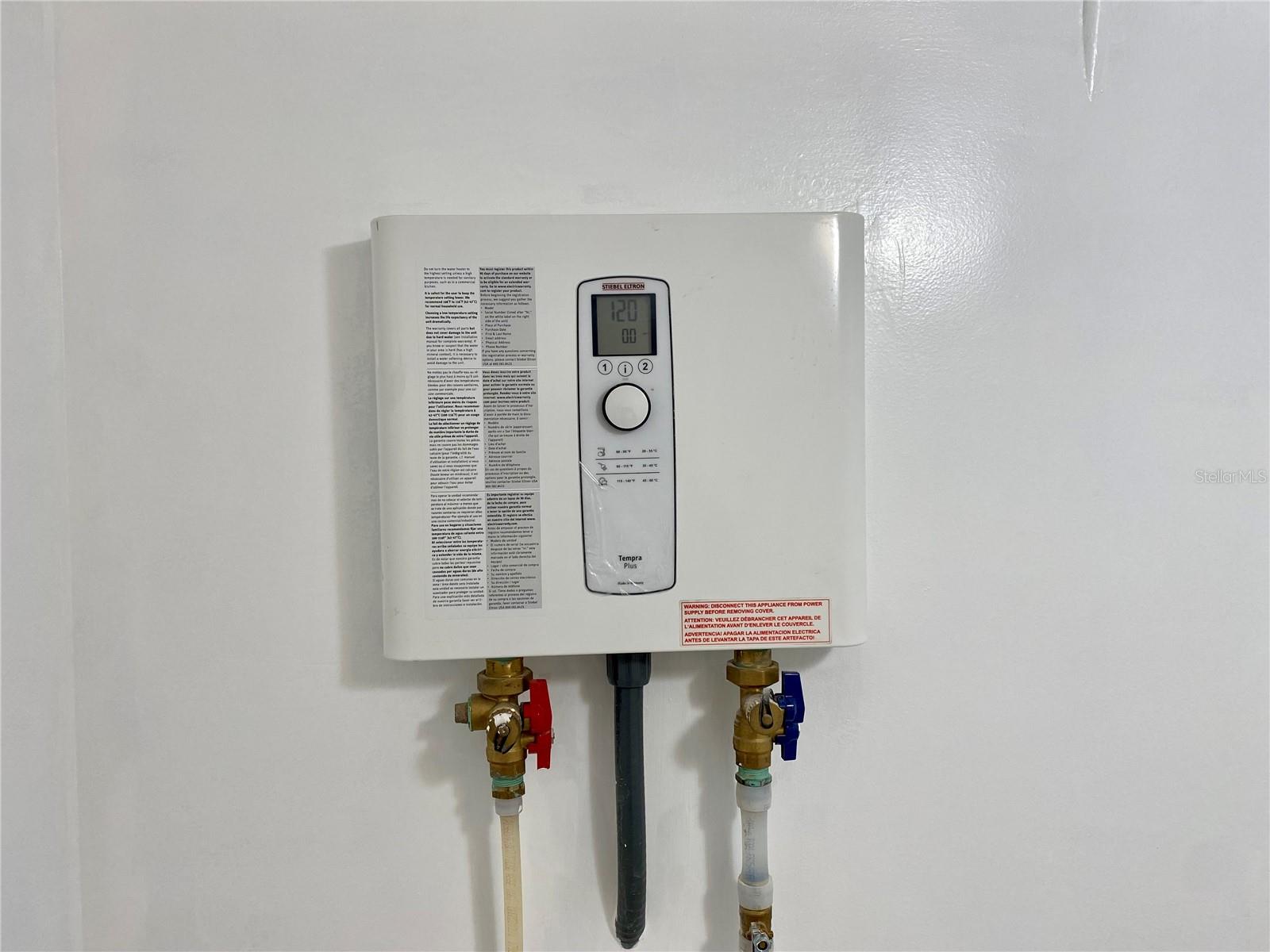 Electric Whole House Tankless Water Heater located in Laundry Room.