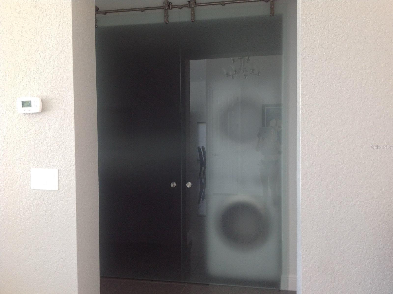 Pre-Storm view of the laundry closet with the frosted glass barn doors closed