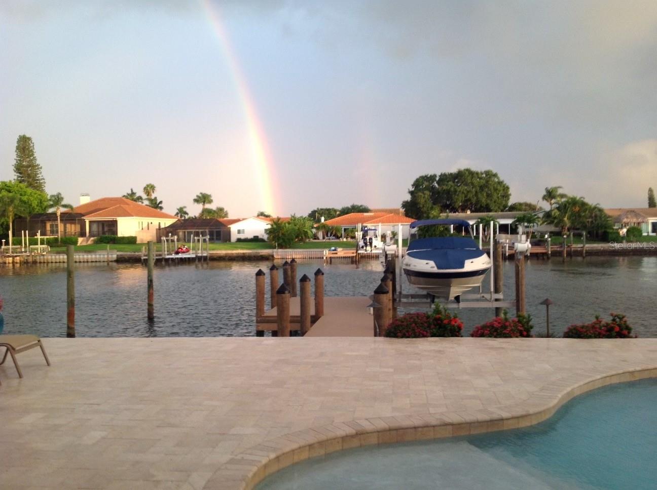 Pre-storm photo of the travertine pool deck, dock and boat lift