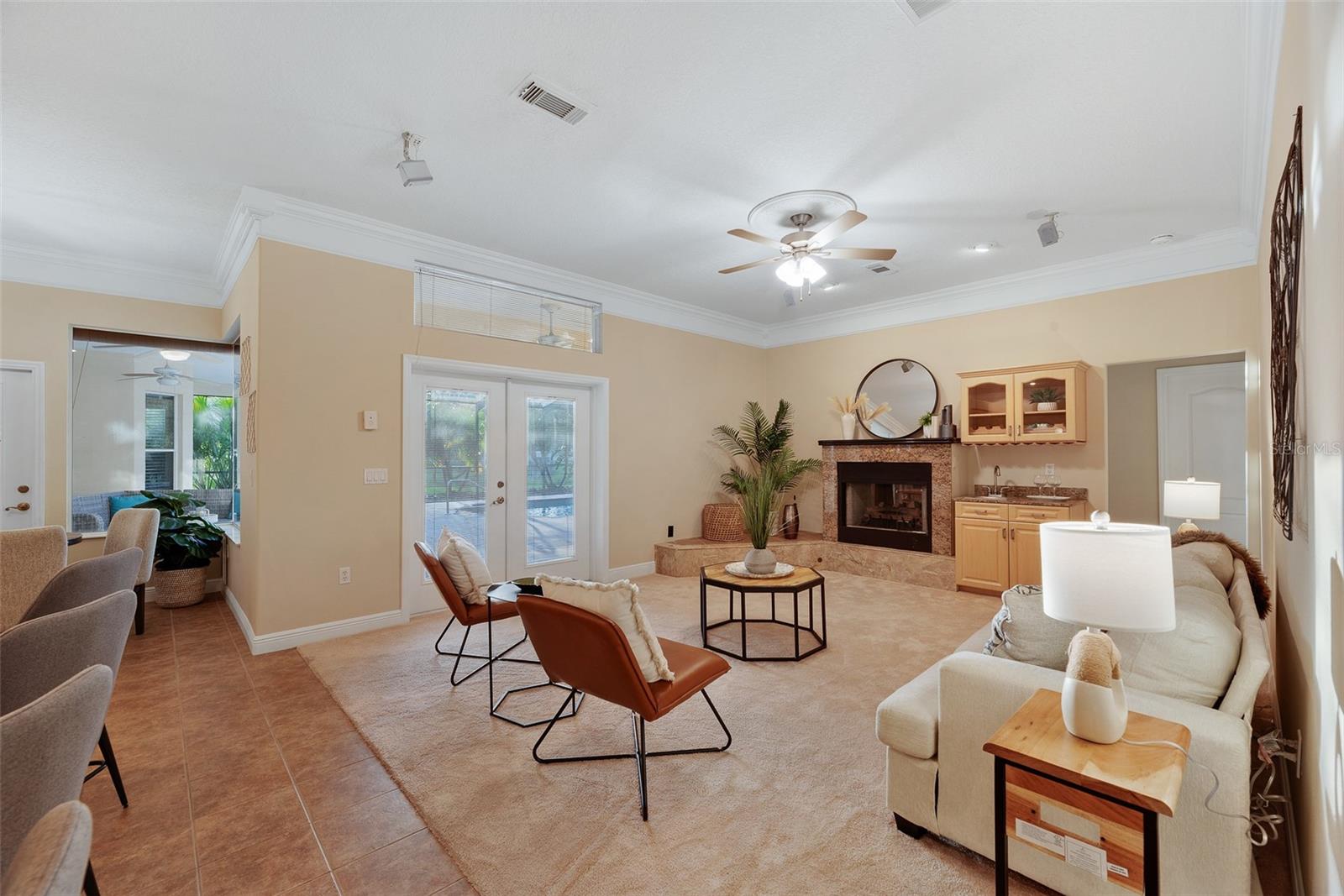 Another set of french doors in the family room provide access and views to the pool.