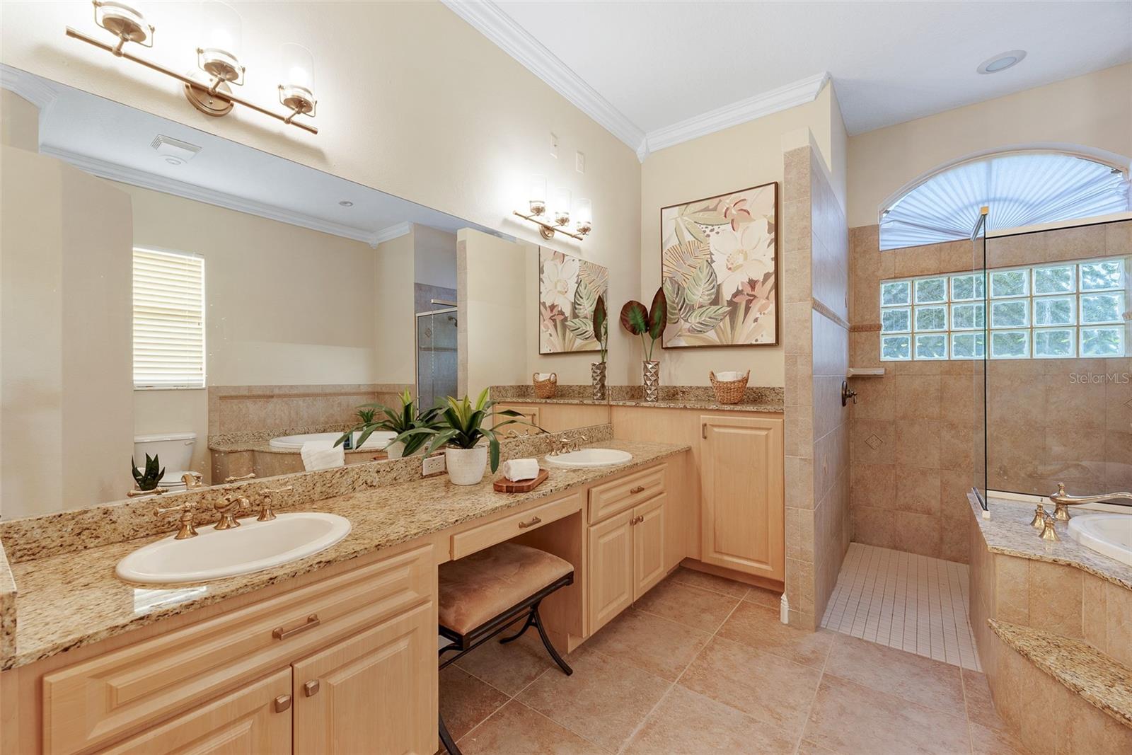 The primary spa-like sanctuary bathroom has dual sinks, a garden tub, and a separate shower.