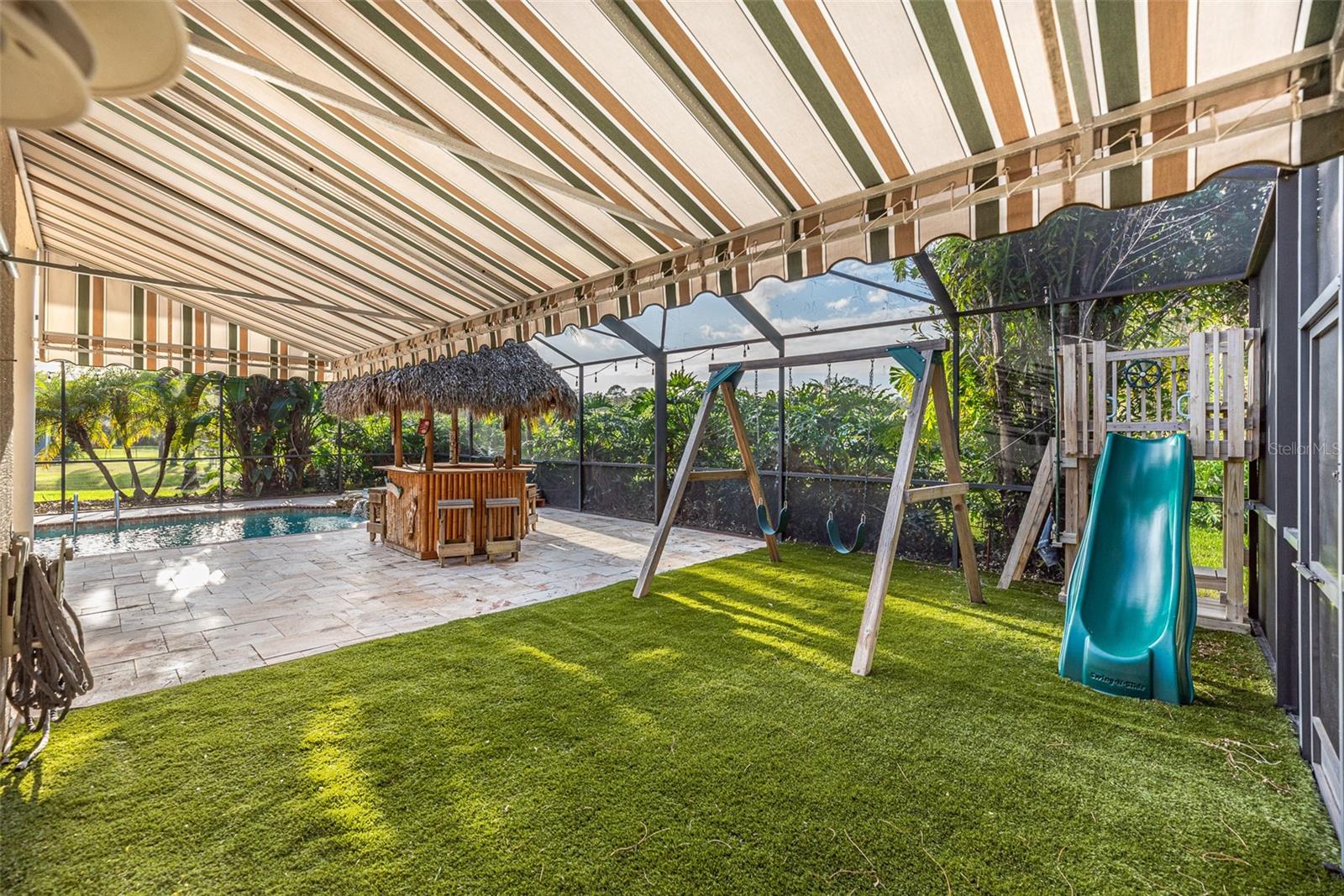 There is a safe, padded surface under the play structure, a sun shade, and a convenient access to a poolside bathroom—perfect for hours of family fun.