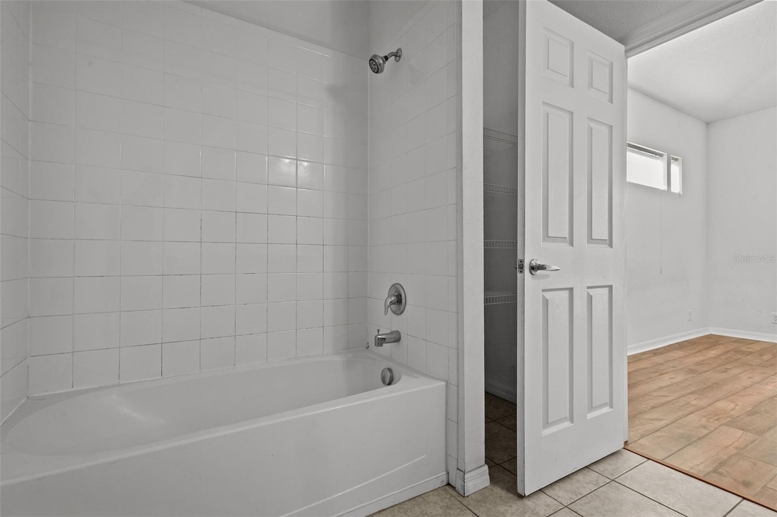 Primary en suite bathroom - double sinks, granite counters, tub with shower