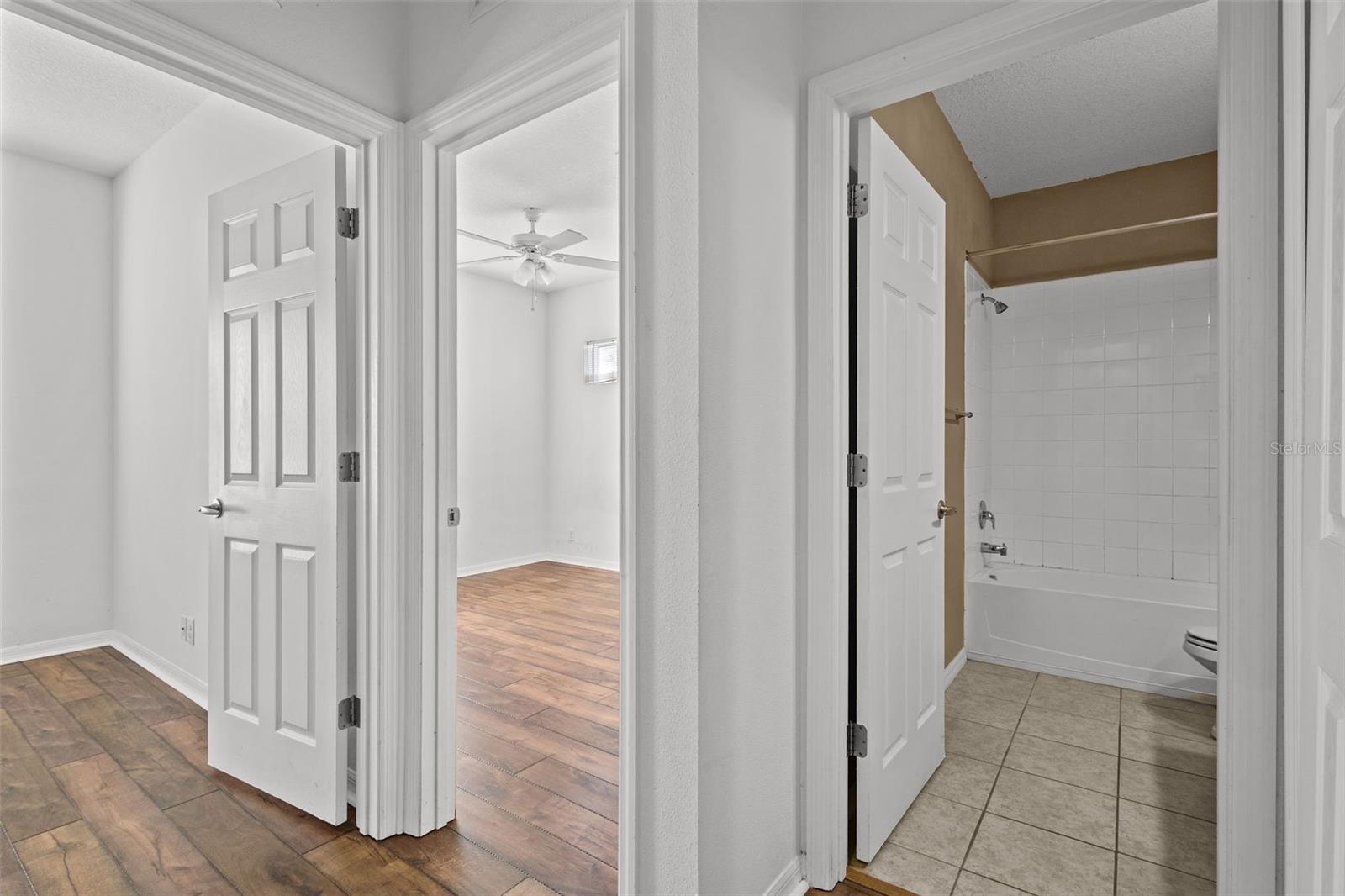 Upstairs hallway showing 2 secondary bedrooms and full bathroom