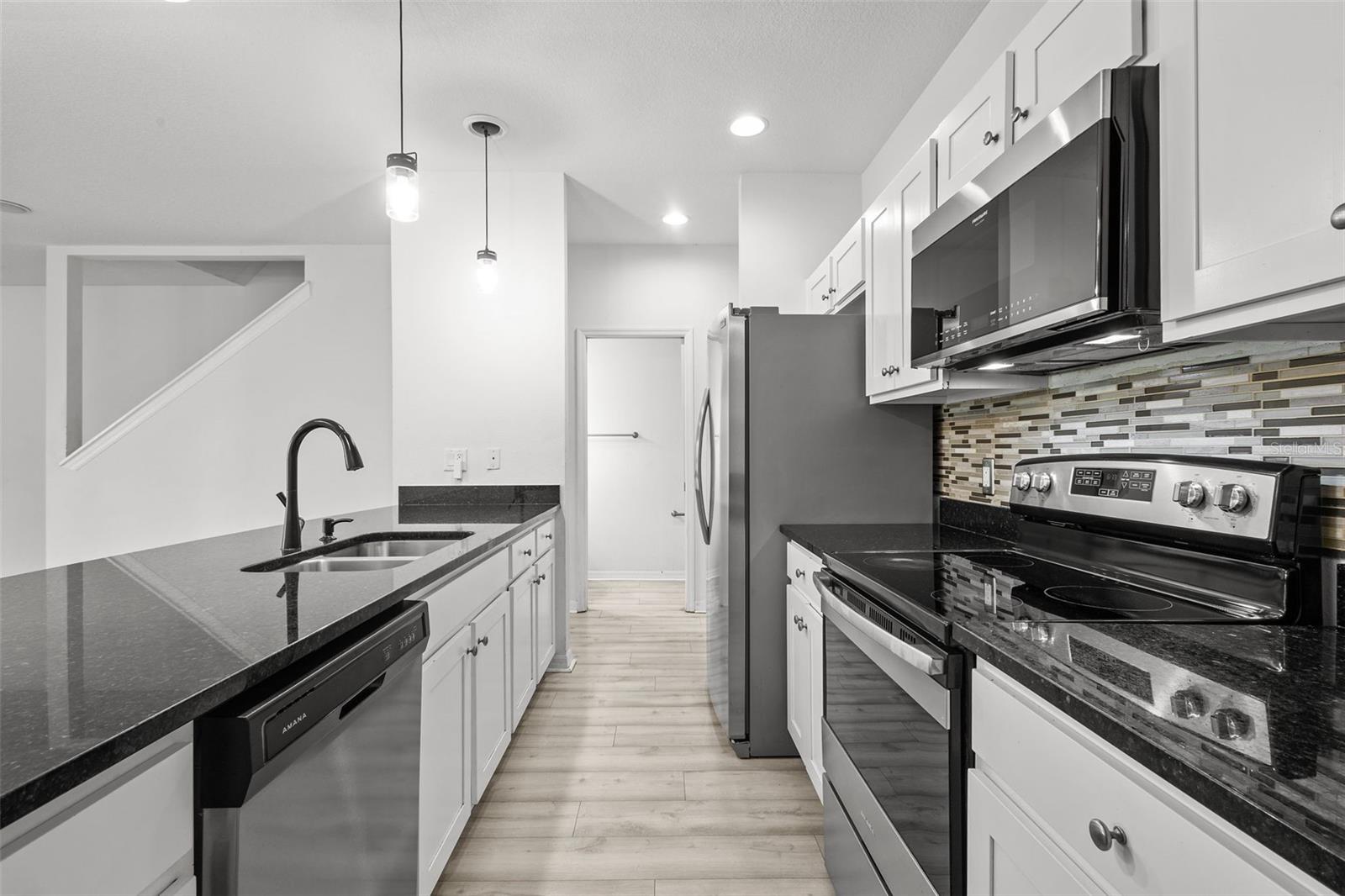 Kitchen with granite countertops and stainless steel appliances