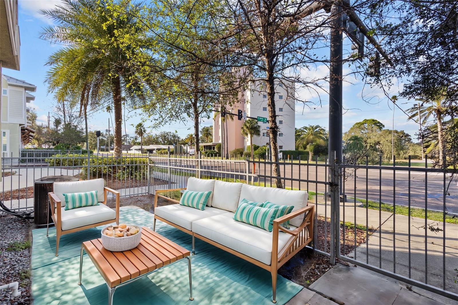 Front of home, courtyard area with view of golf course - virtually staged